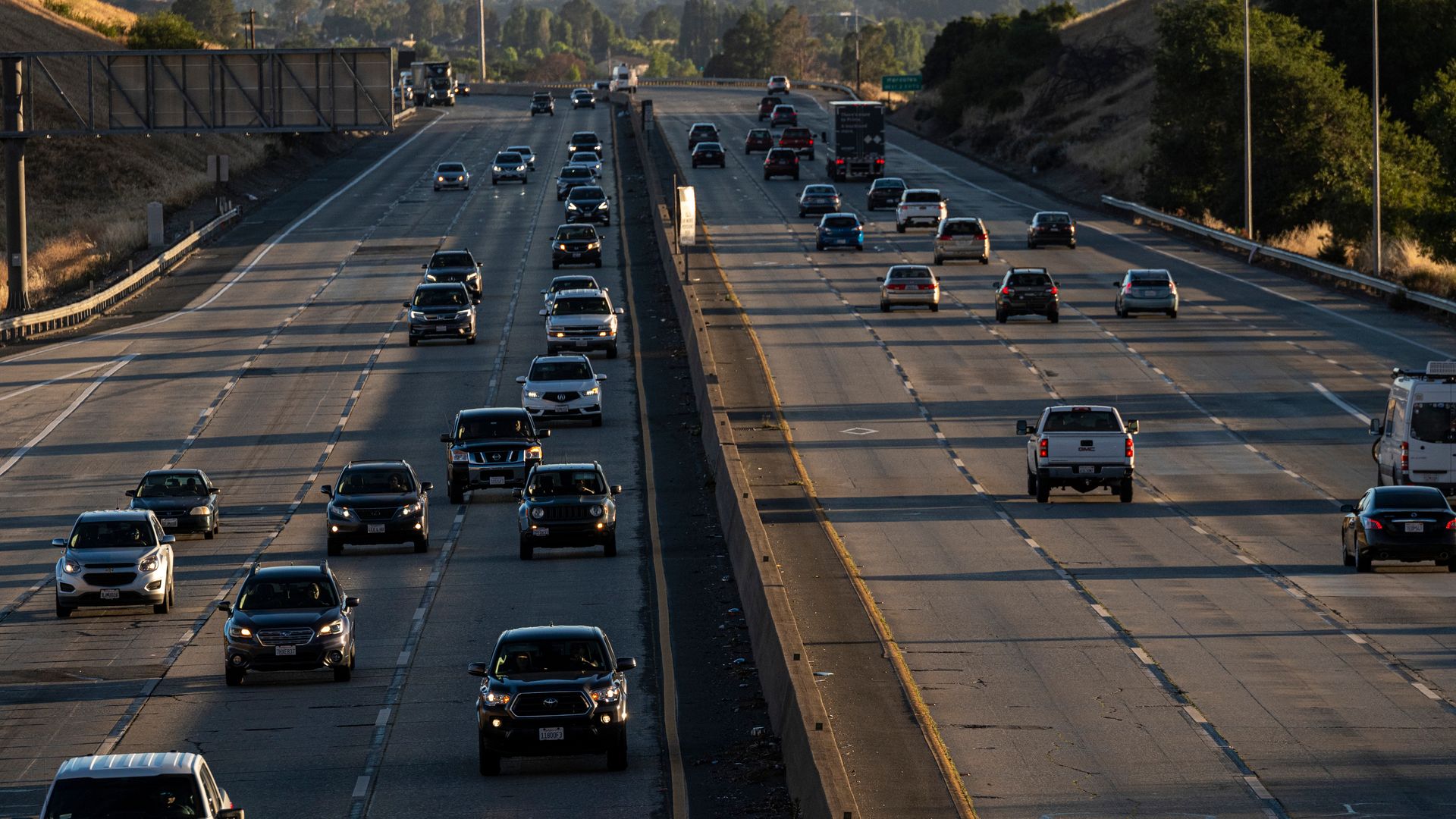 Cars hit the road on a California highway.