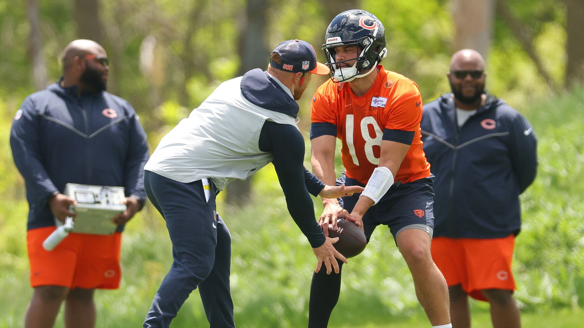 Photo of a football player on a field practicing