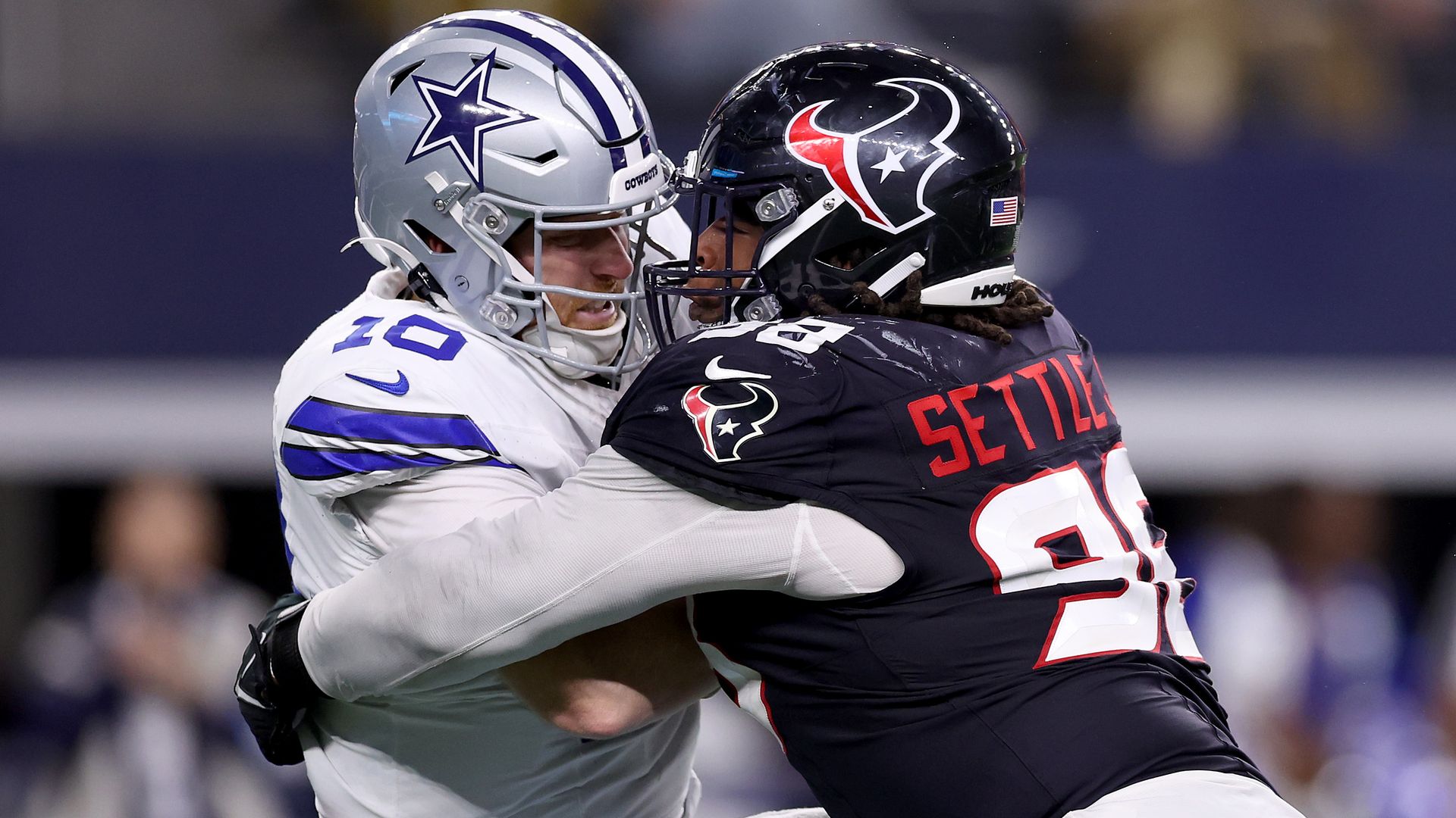 a photo of the Dallas Cowboys quarterback getting sacked by a Houston Texan