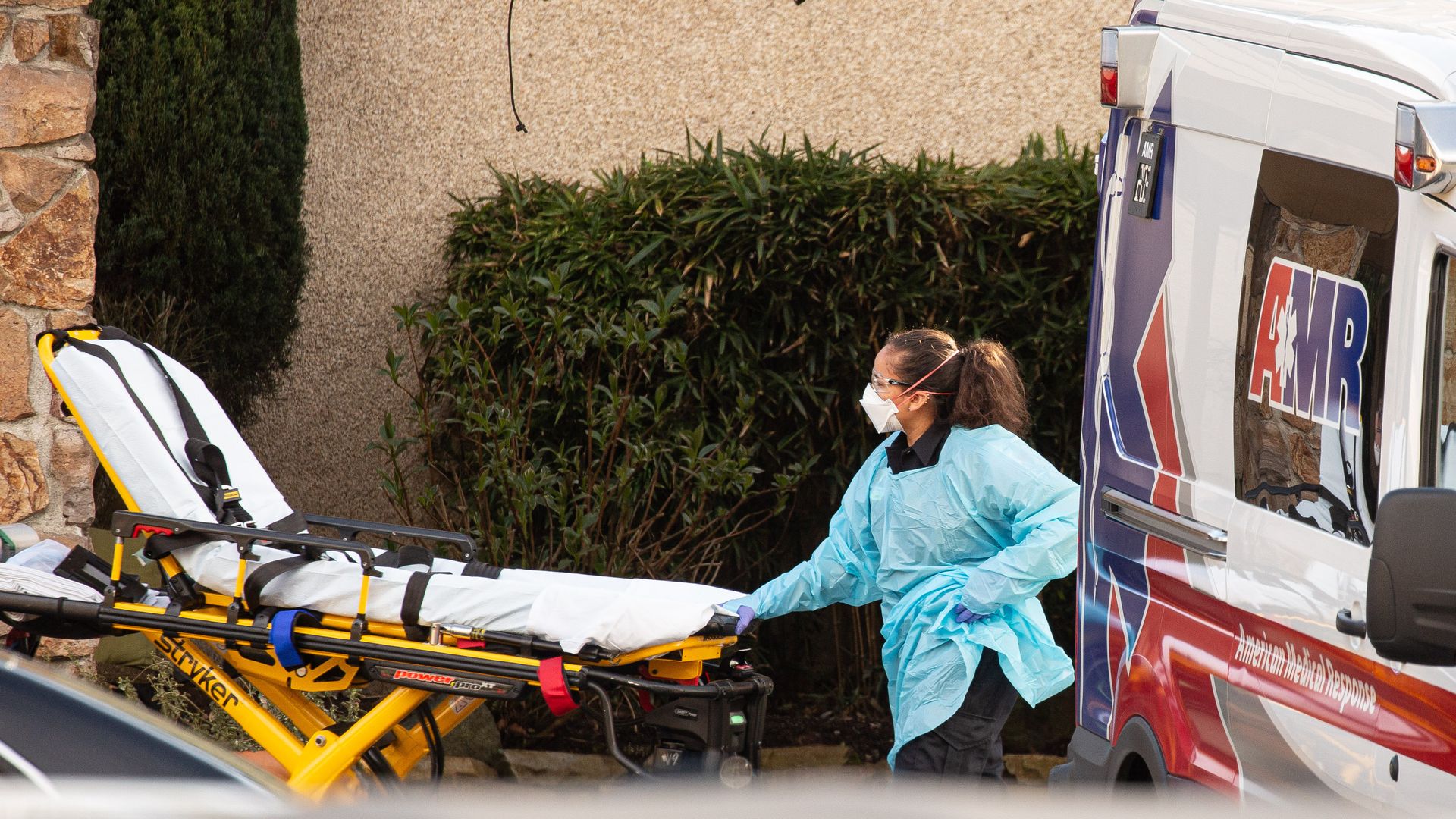 A healthcare worker prepares to transport a patient on a stretcher into an ambulance at Life Care Center of Kirkland on February 29, 2020 in Kirkland, Washington.