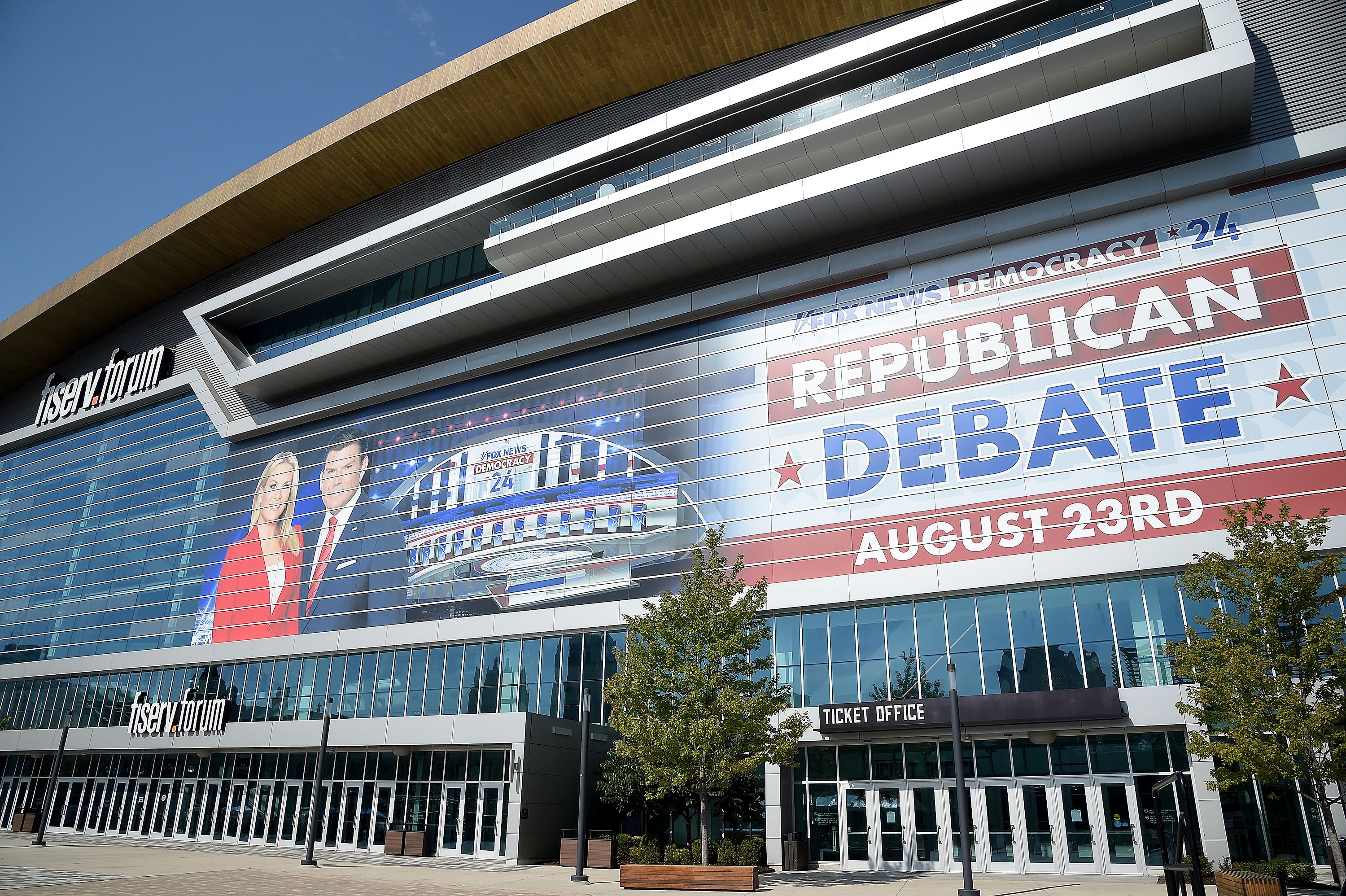 A large banner, including the images of Bret Baier and Martha MacCallum, hangs over the arena where the first GOP debate is to be held.