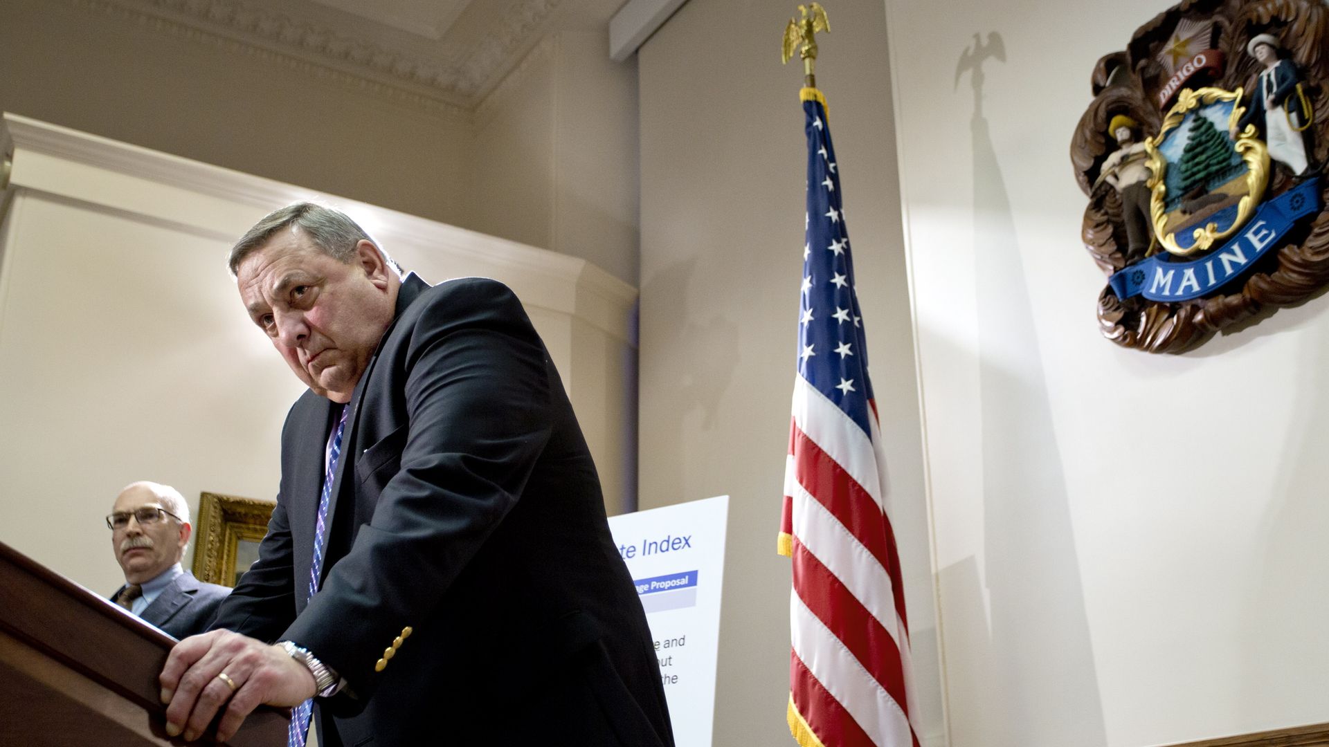 Governor LePage leaning over a podium