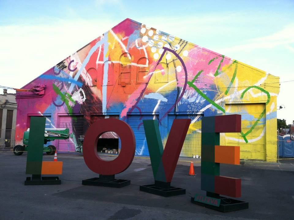a brightly colored building with a LOVE sign in front.