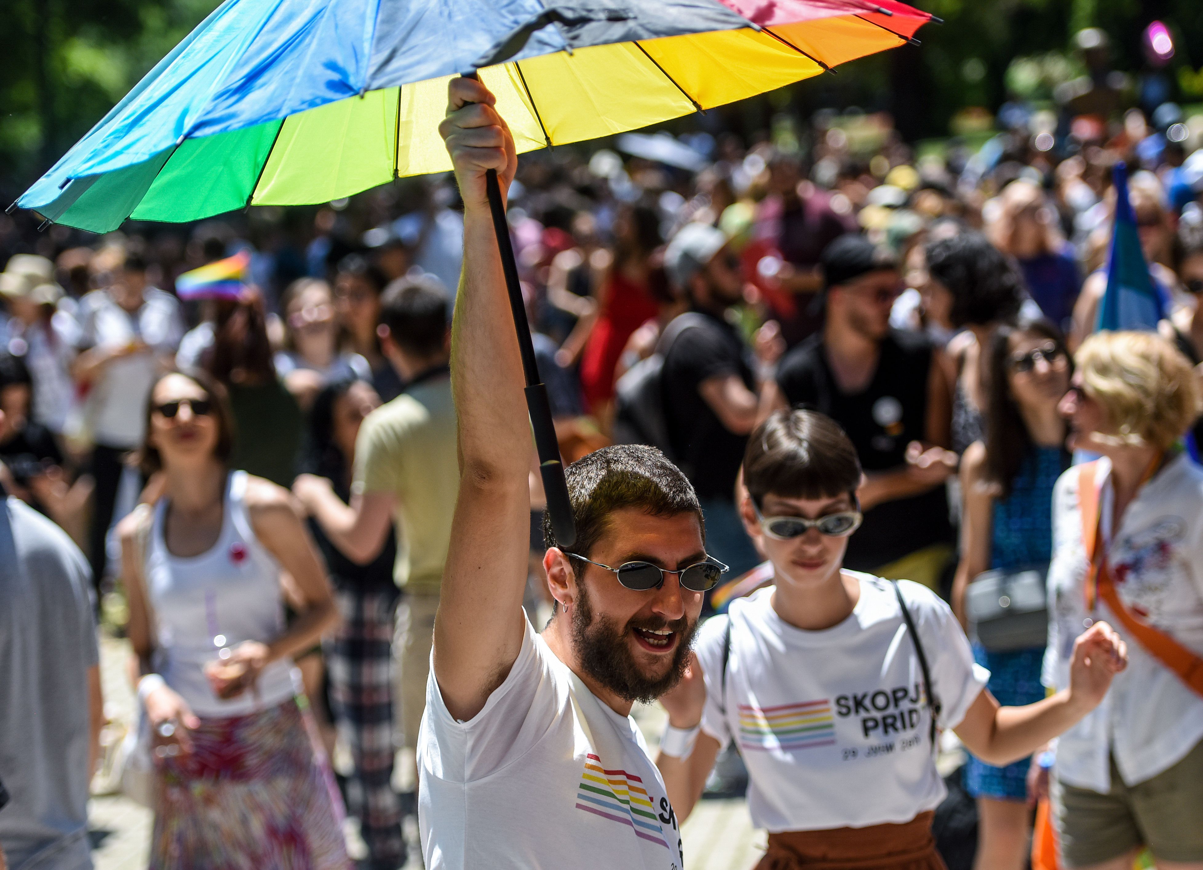 A participant holds an umbrella in the rainbow flag colours during the "Skopje Pride" march in downtown Skopje, on June 29.
