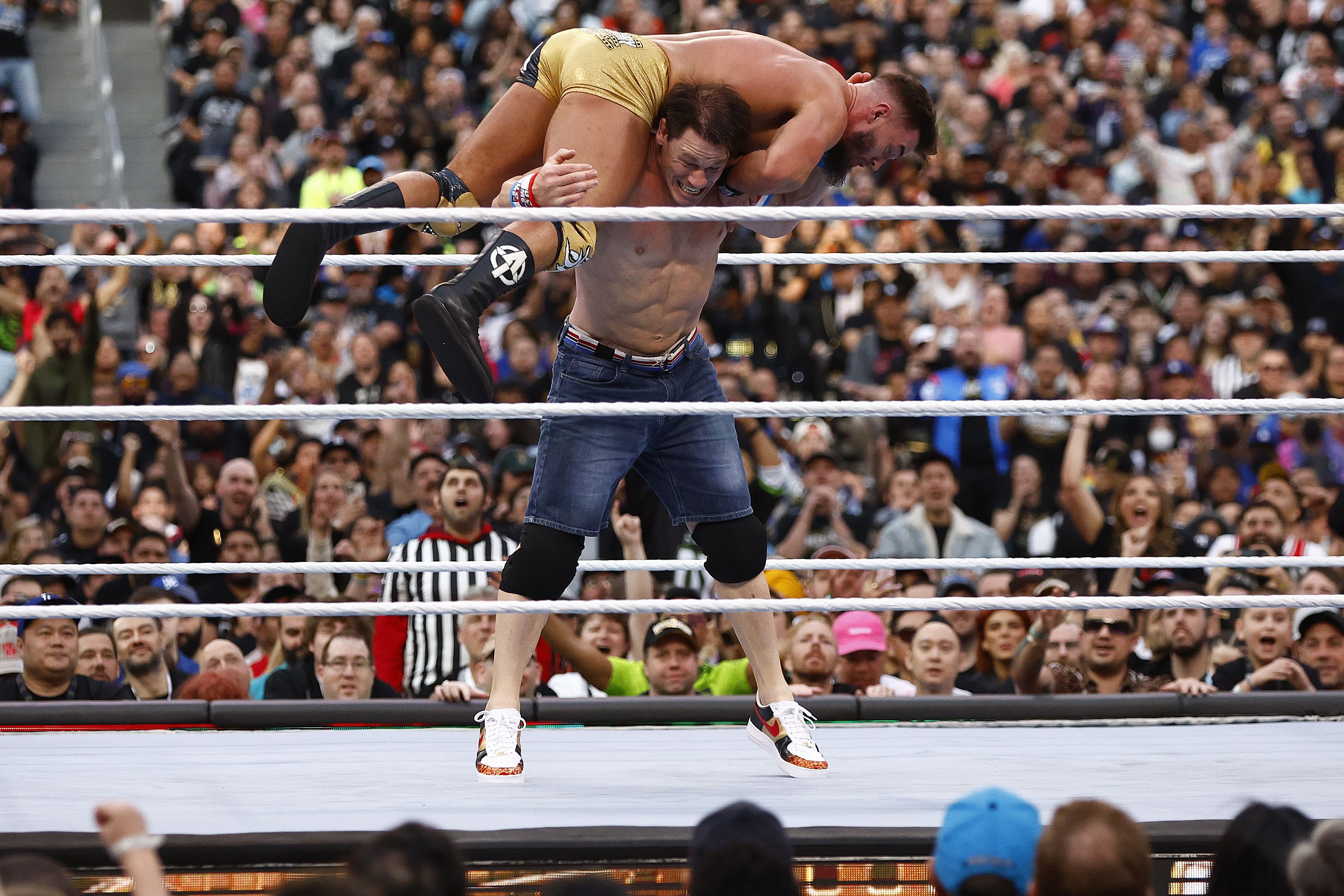 John Cena holds Austin Theory on his shoulders during a match at WrestleMania in April.