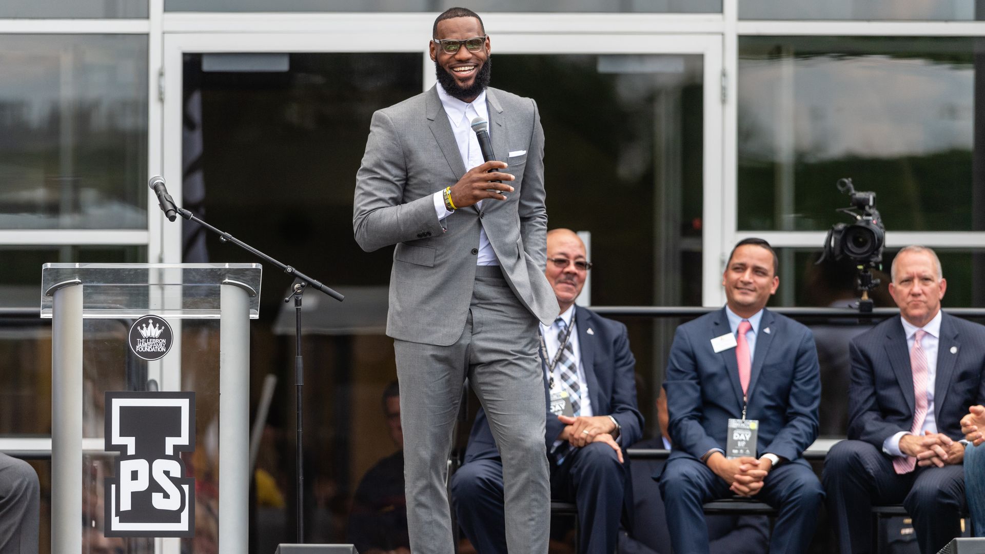 LeBron James smiling, speaking to a crowd.