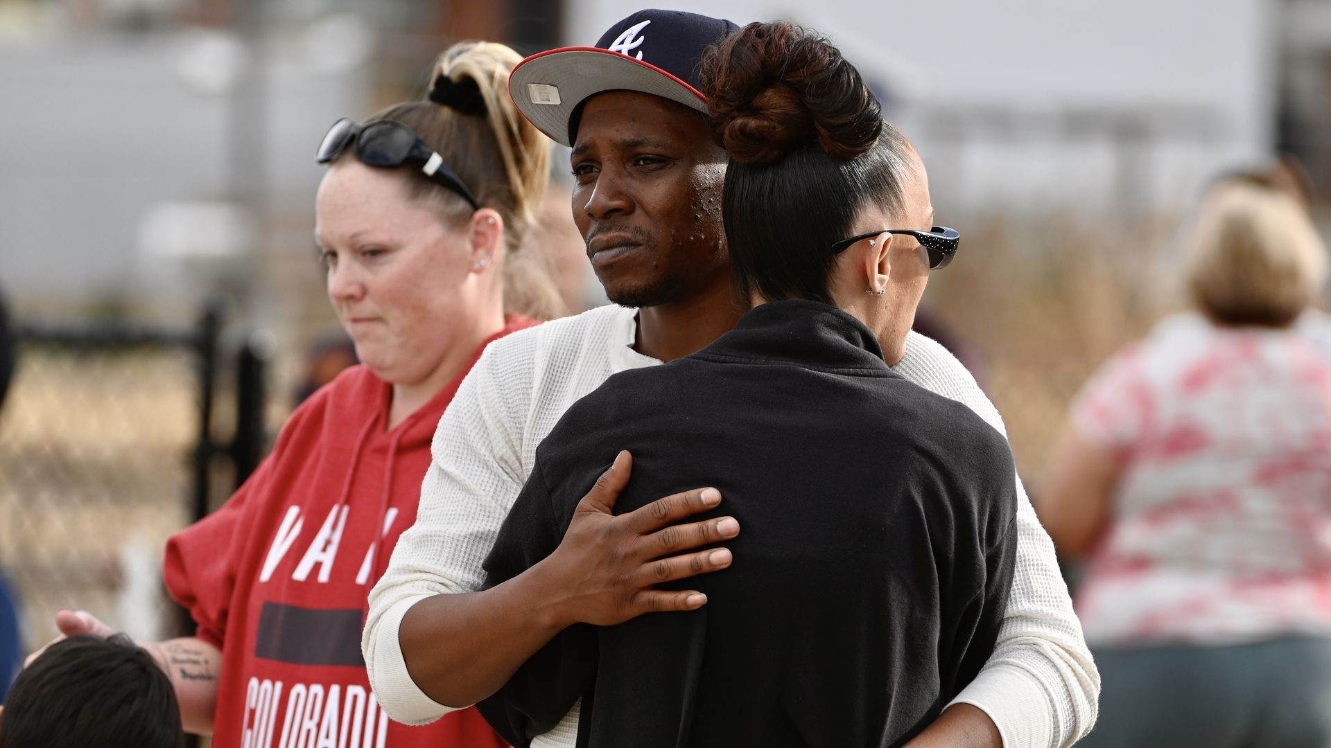 People gather outside Hinkley High School in Aurora after three people were shot in the school parking lot. Photo: Andy Cross/The Denver Post via Getty Images
