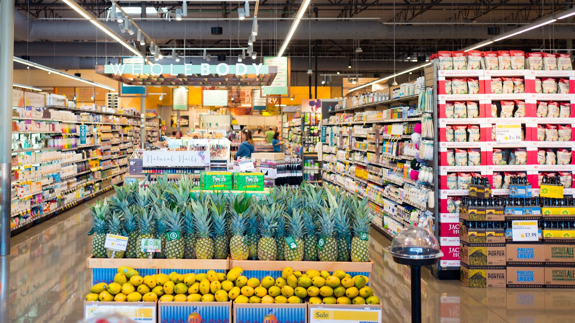 A headlong view of a Whole Foods aisle stocked with colorful boxes