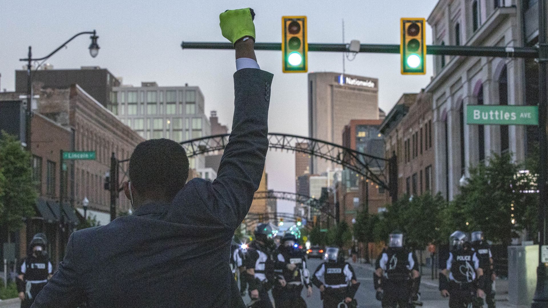 A man holds up his fist in front of the police line during the demonstration.