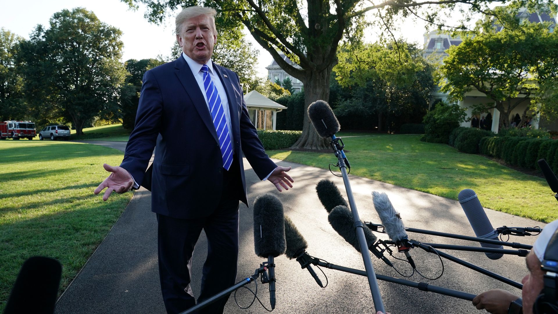 President Donald Trump speaks to members of the media prior to his departure for Camp David