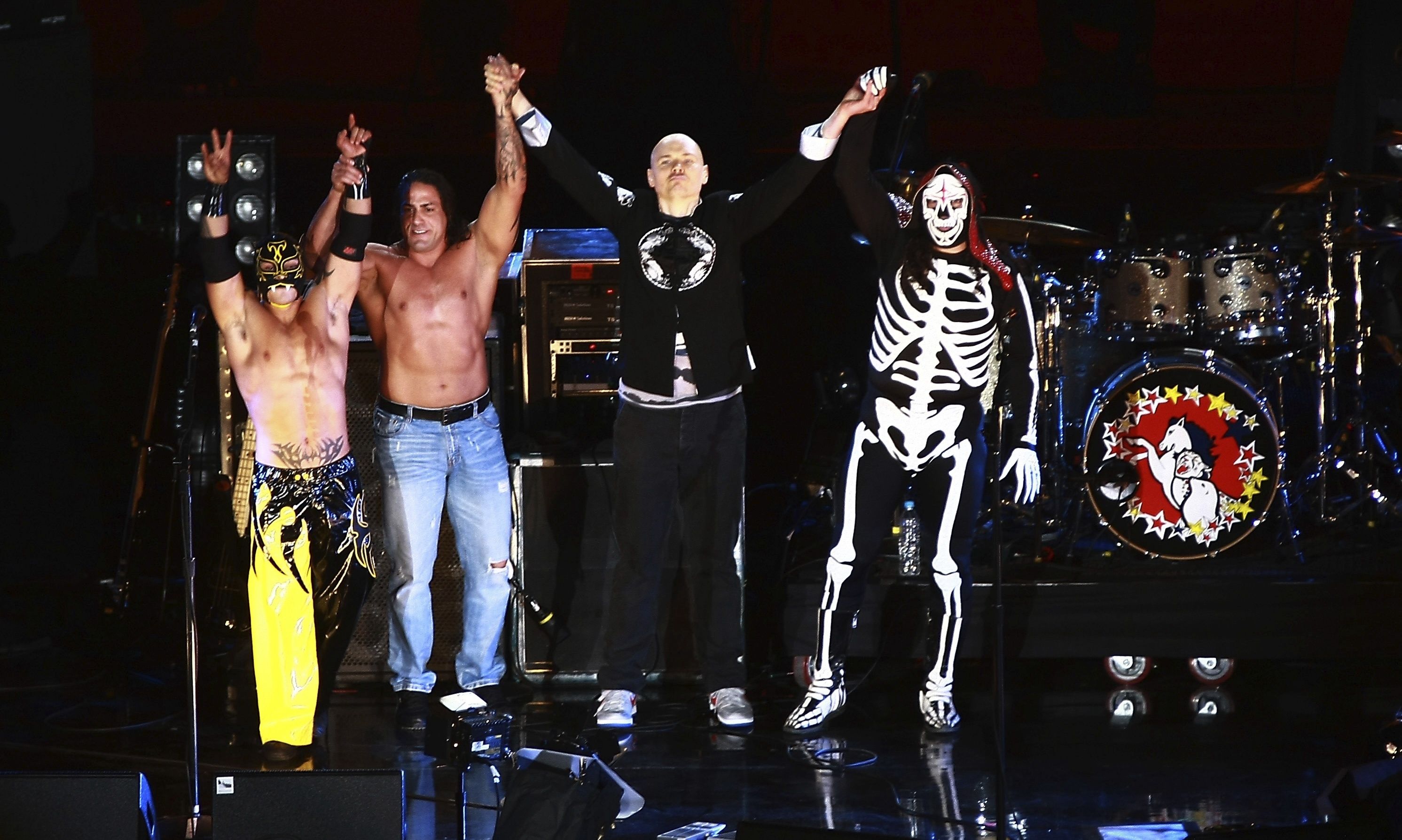 Photo of wrestlers on stage with musicians 
