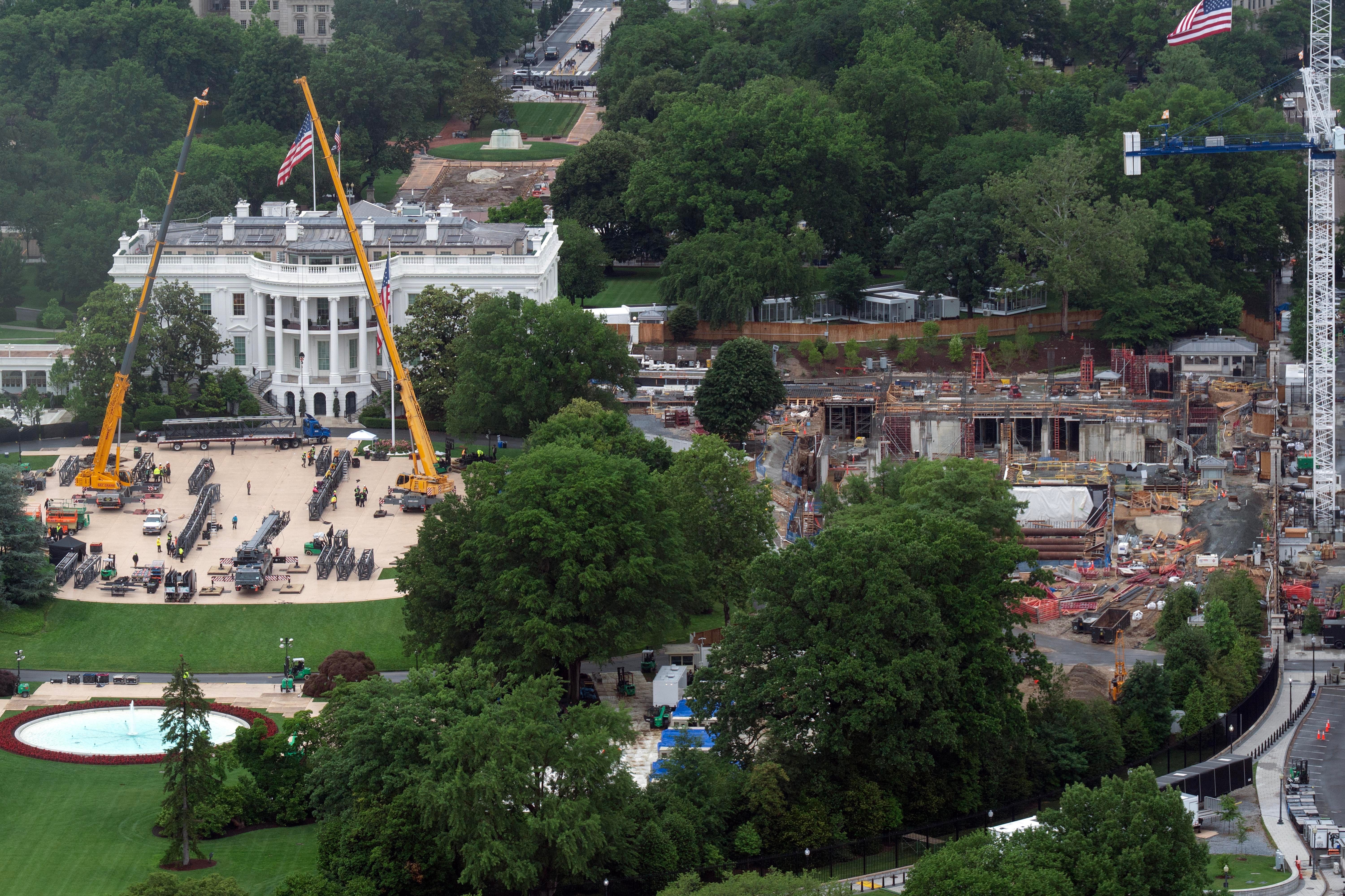 Work continues on the construction of the ballroom at the White House and a UFC cage on the South Lawn, Saturday, May 23, 2026, in Washington. (AP Photo/Jose Luis Magana)