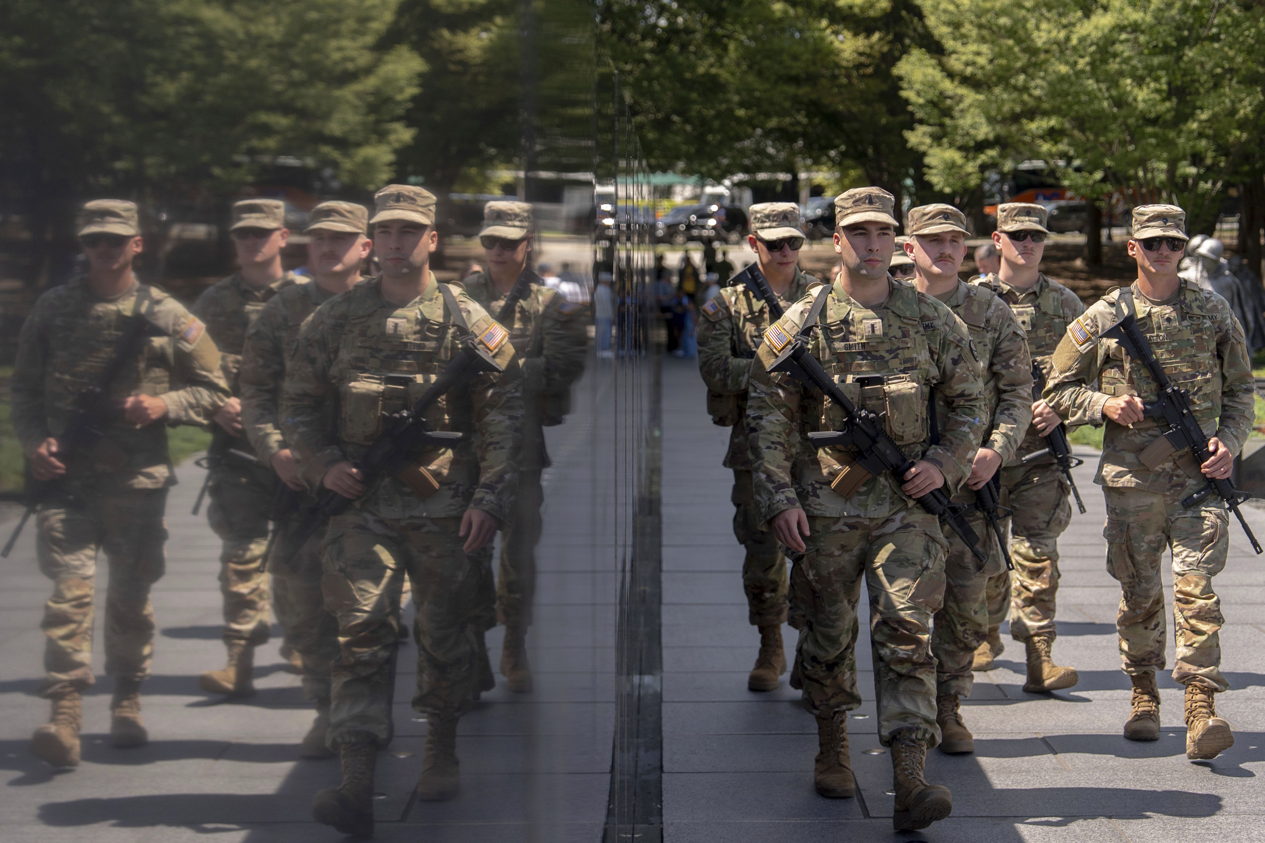 Armed West Virginia National Guardsmen patrol at the Korean War Veterans Memorial on Tuesday.