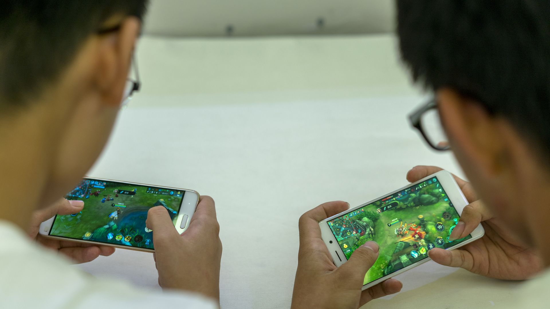 Players practice the mobile game Arena of Valor in a shopping mall in Tianjin, China.