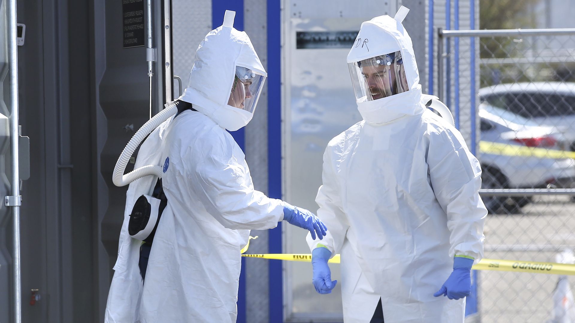 Battelle workers in protective gear as they disinfect face masks