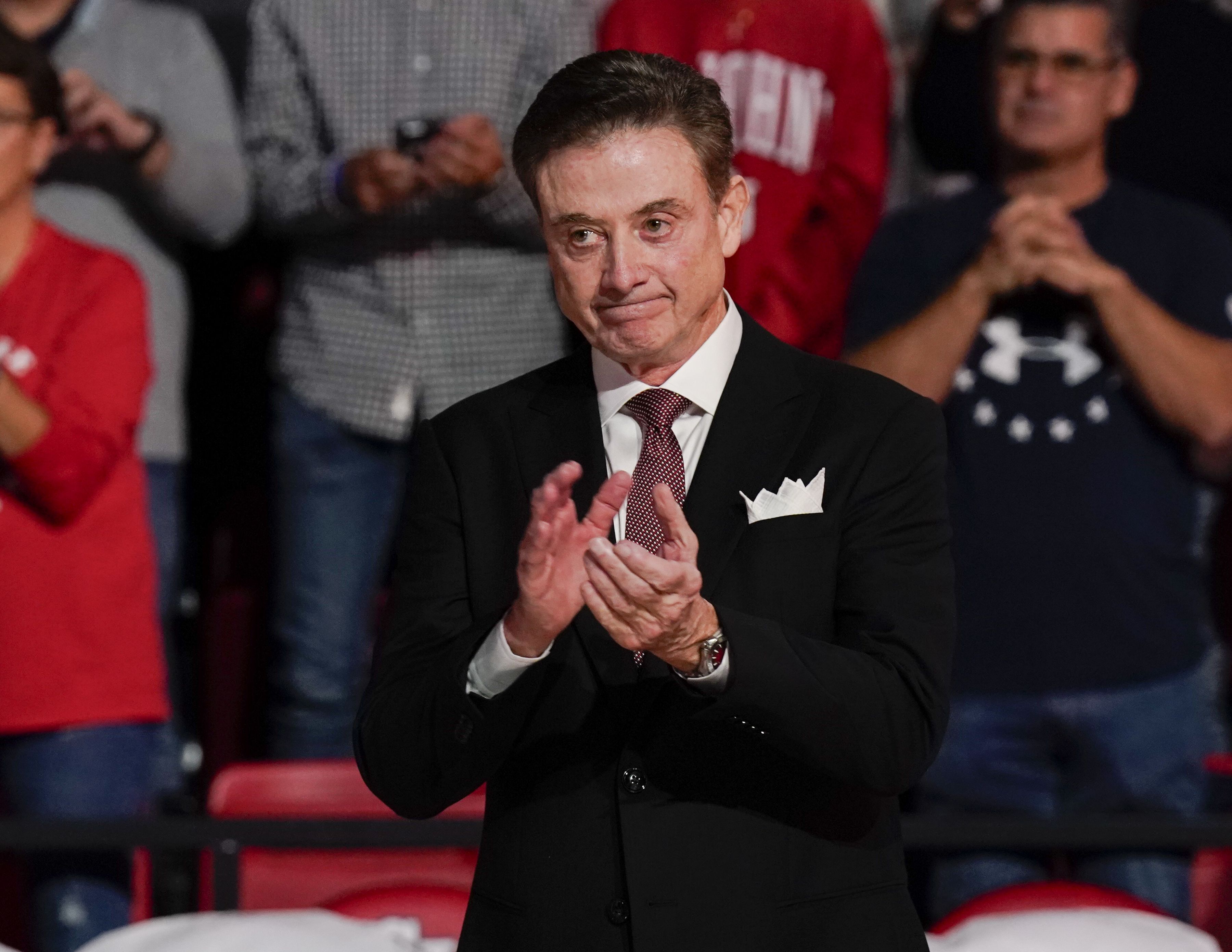 Photo of a basketball coach cheering on his players from the sideline