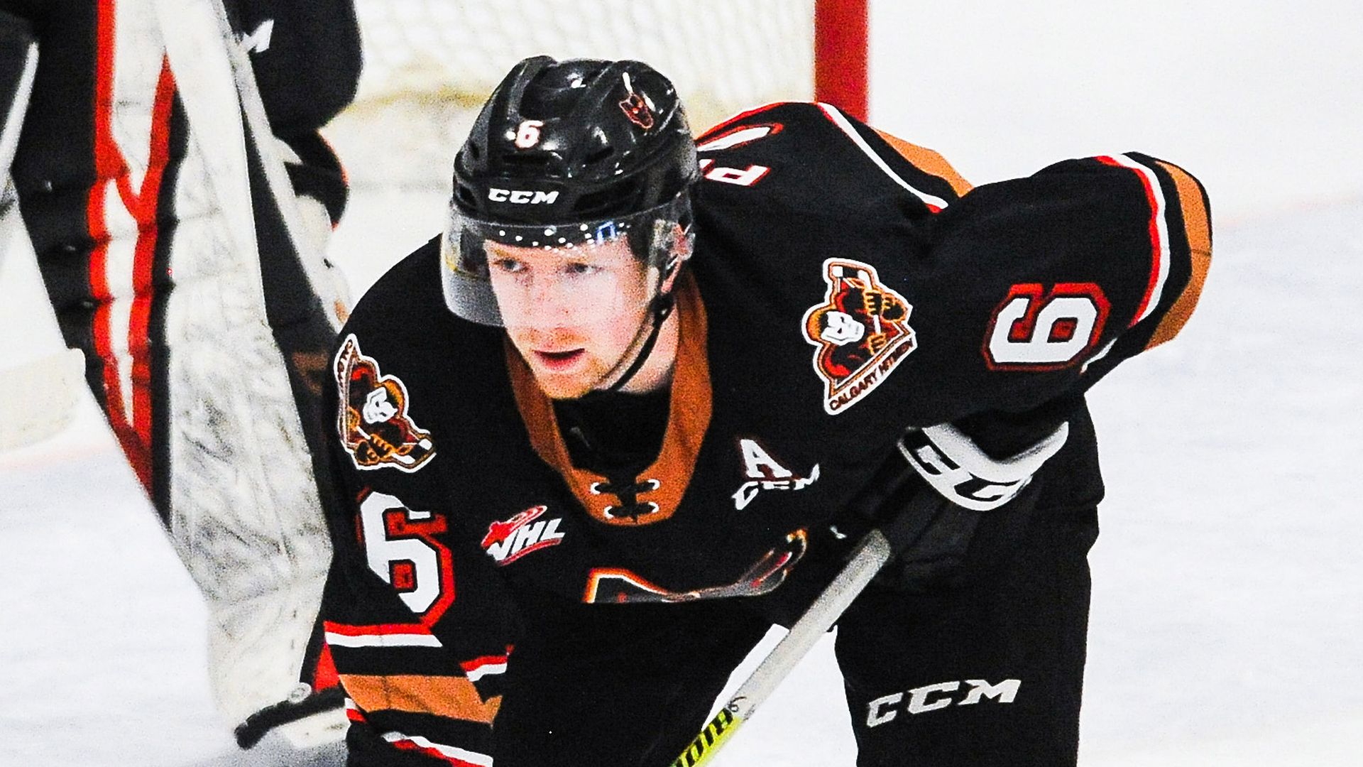 Photo of Luke Prokop in hockey gear crouching down on ice in a match