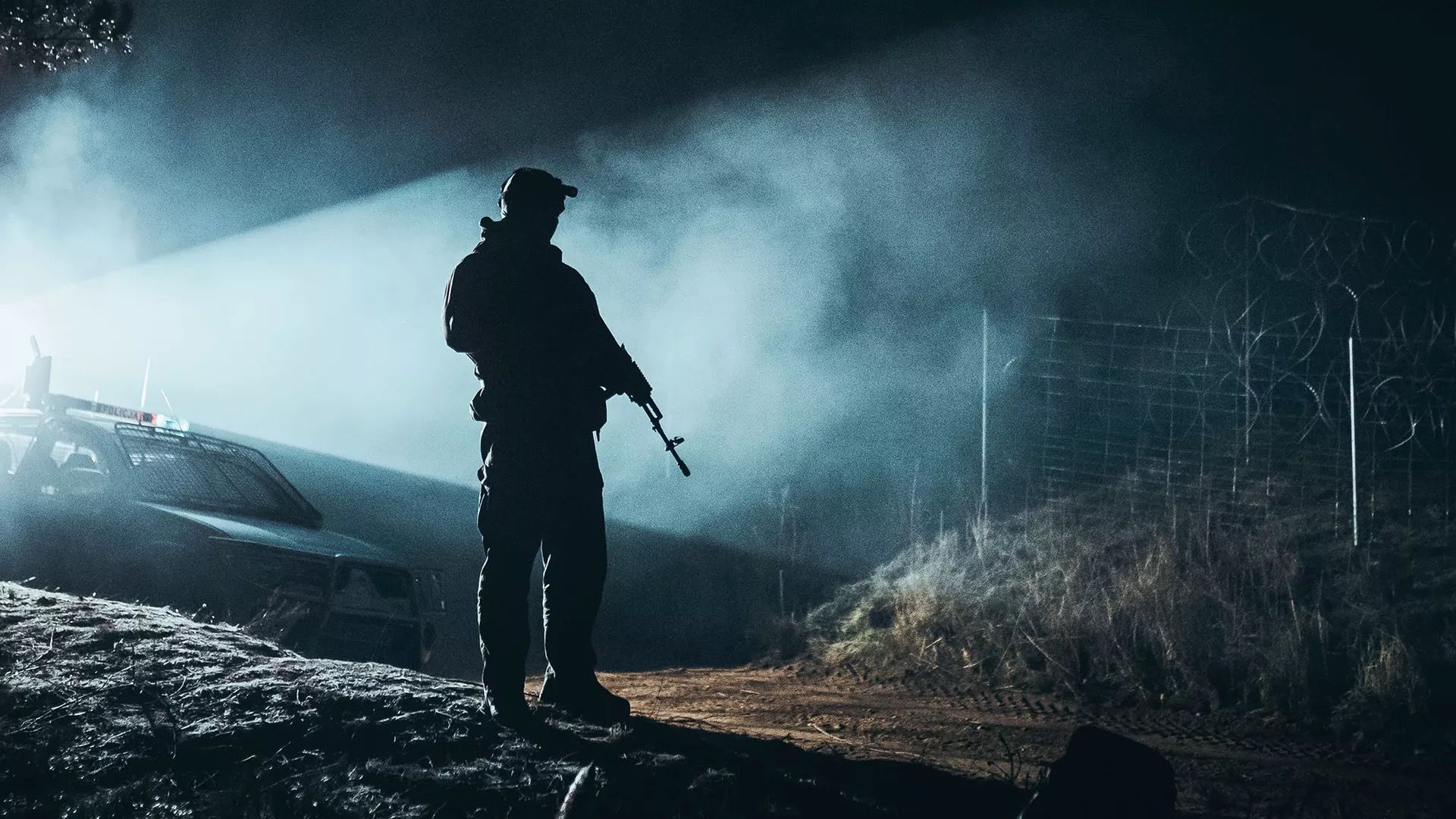 A Polish soldier is seen standing at the Belurus border.