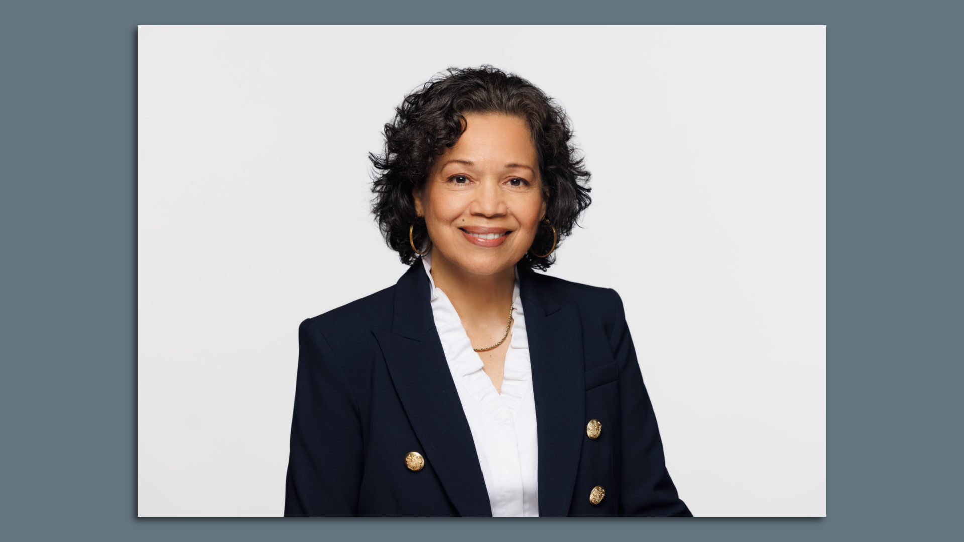 Ingrid Ciprian-Matthews poses. Picture has a dark gray background