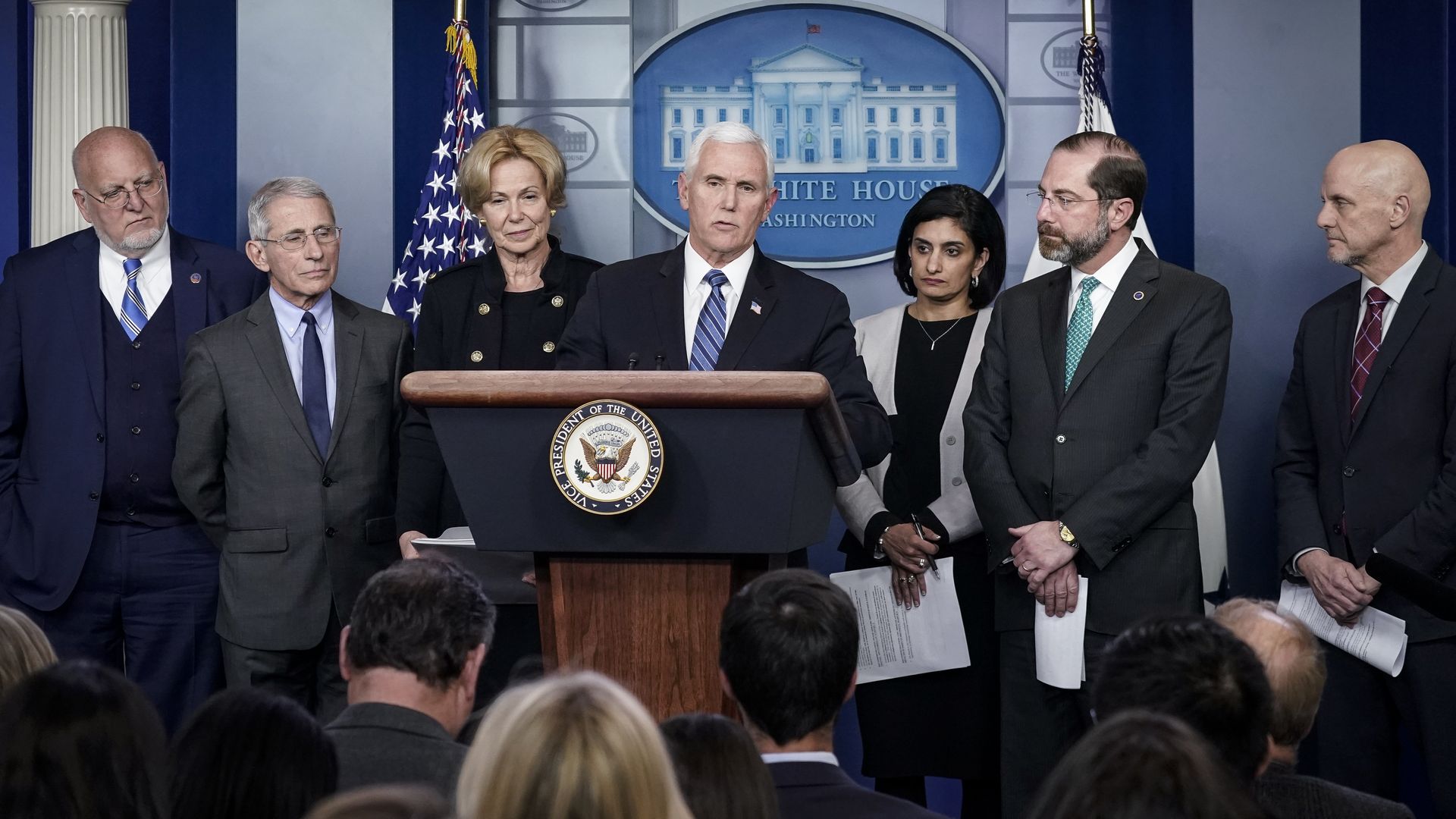 Vice President Mike Pence flanked by top health officials at a news conference