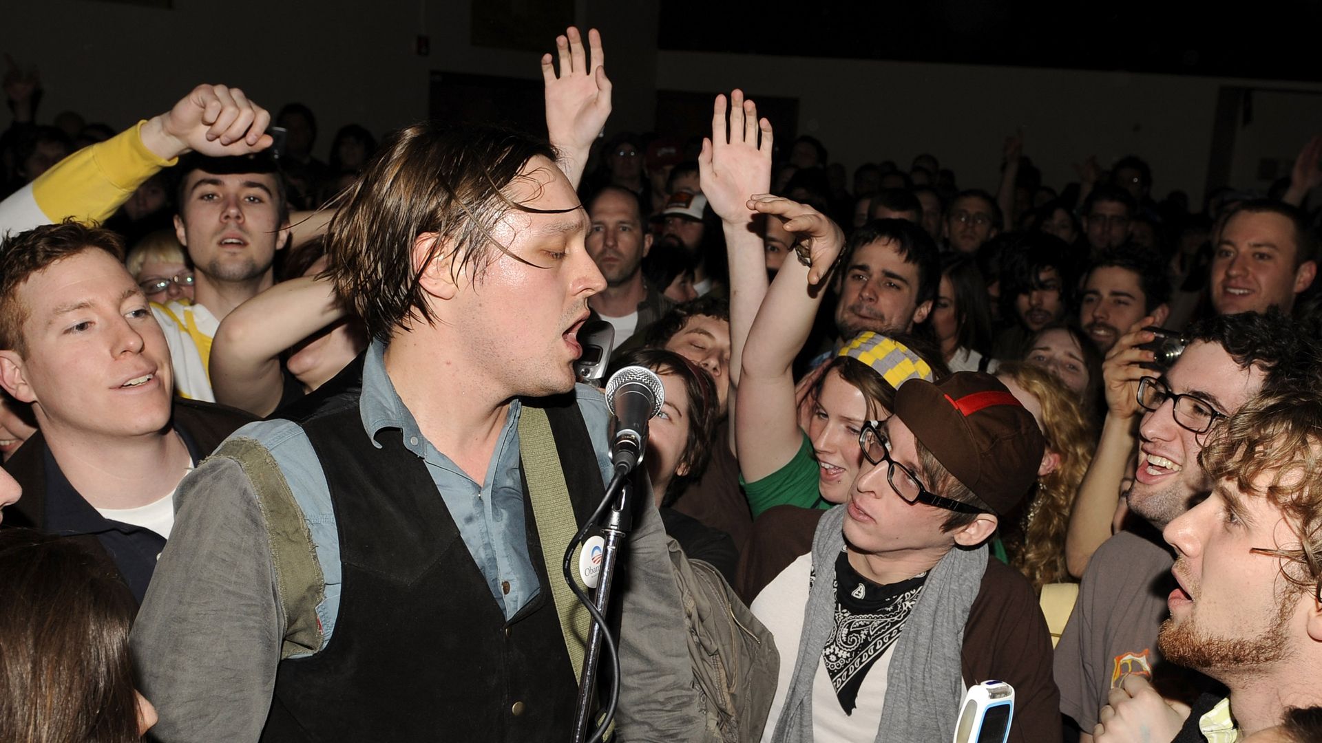 Win Butler of Arcade Fire performs in a crowd. 