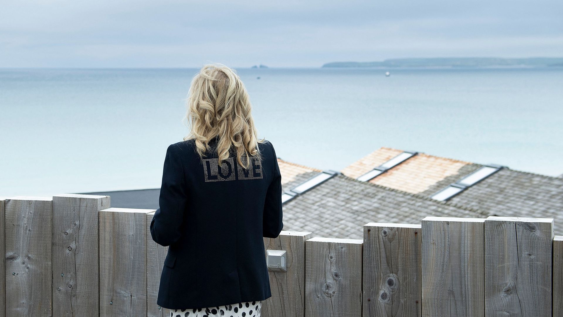 Jill Biden is seen wearing a jacket emblazoned with the word "Love."