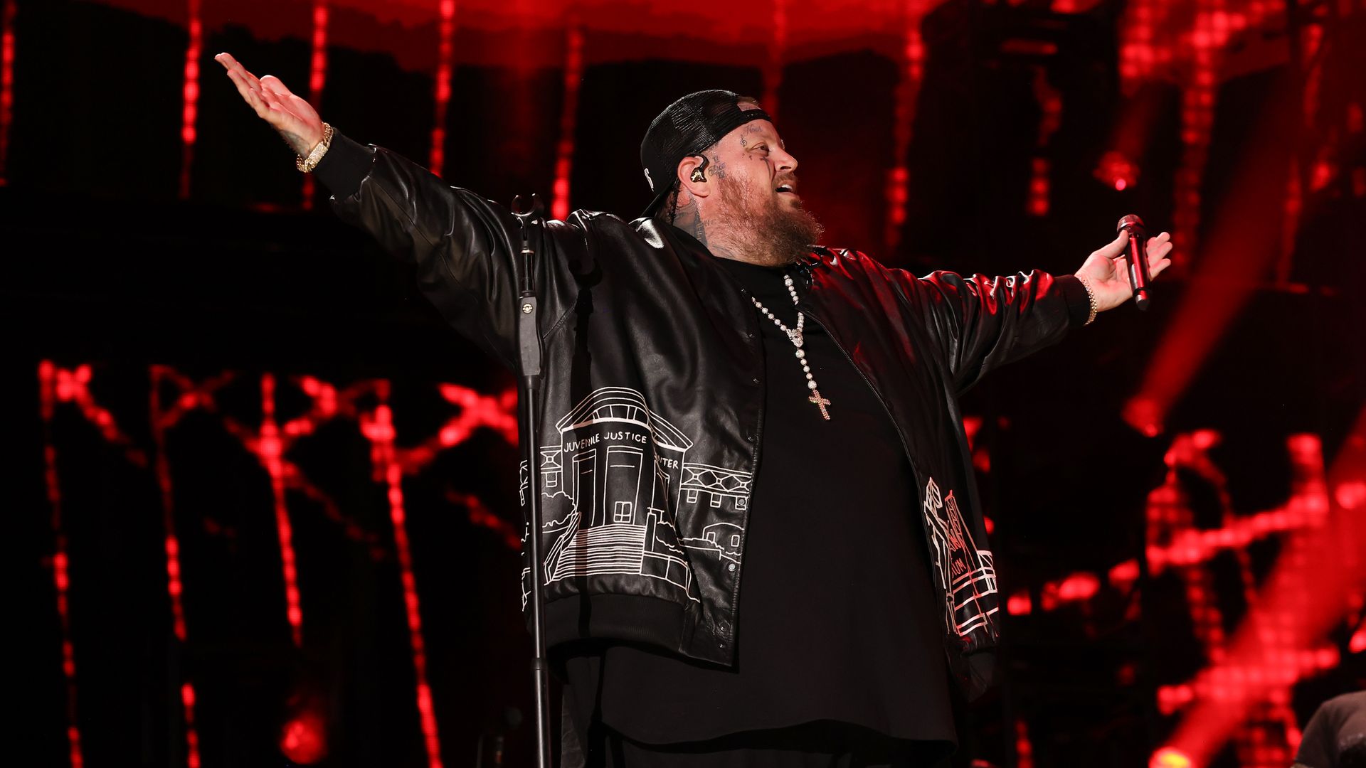 Jelly Roll onstage wearing a jacket that shows an image of the Nashville Juvenile Justice Center.