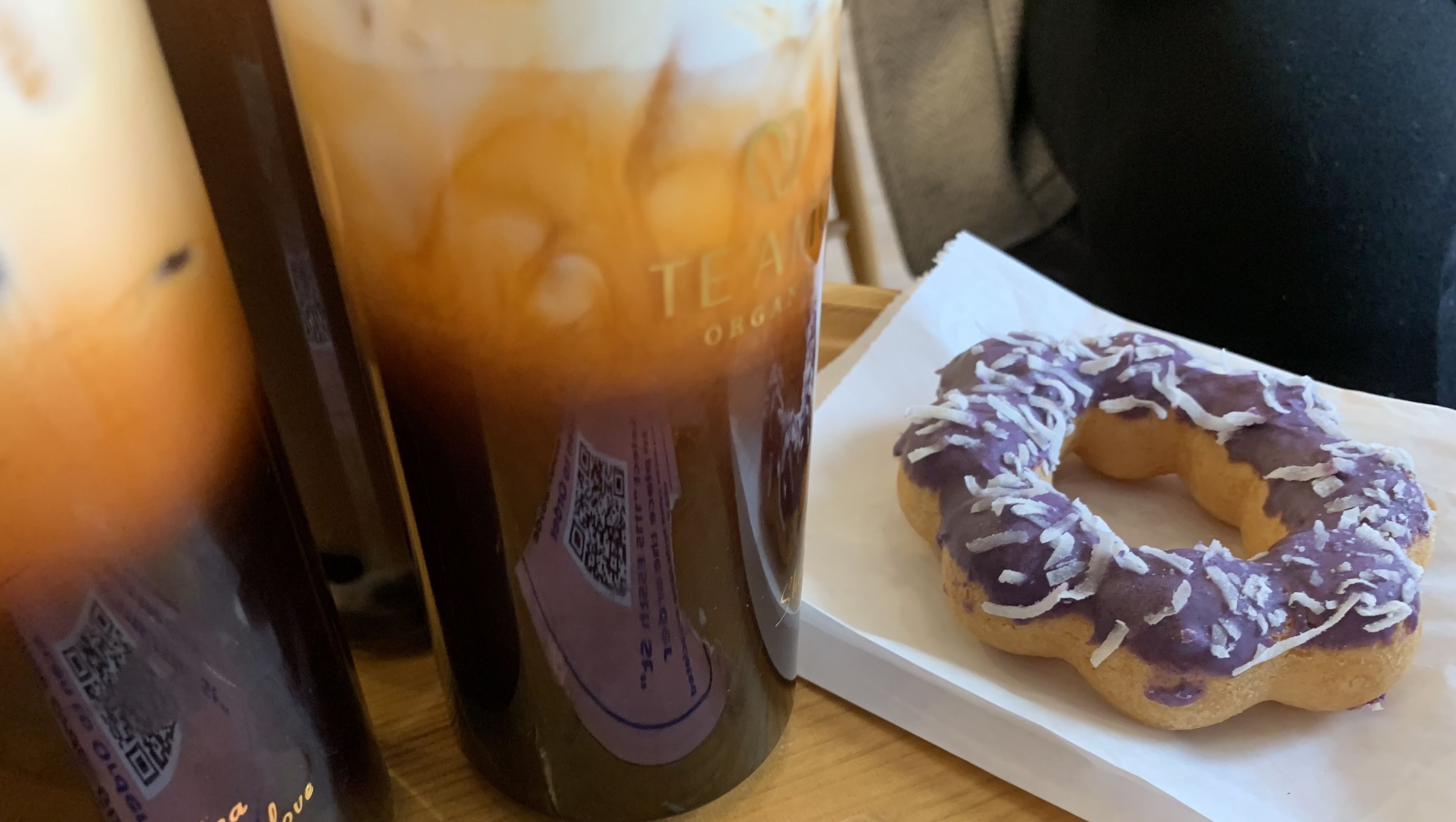 Photo of iced teas and a donut on a table. 