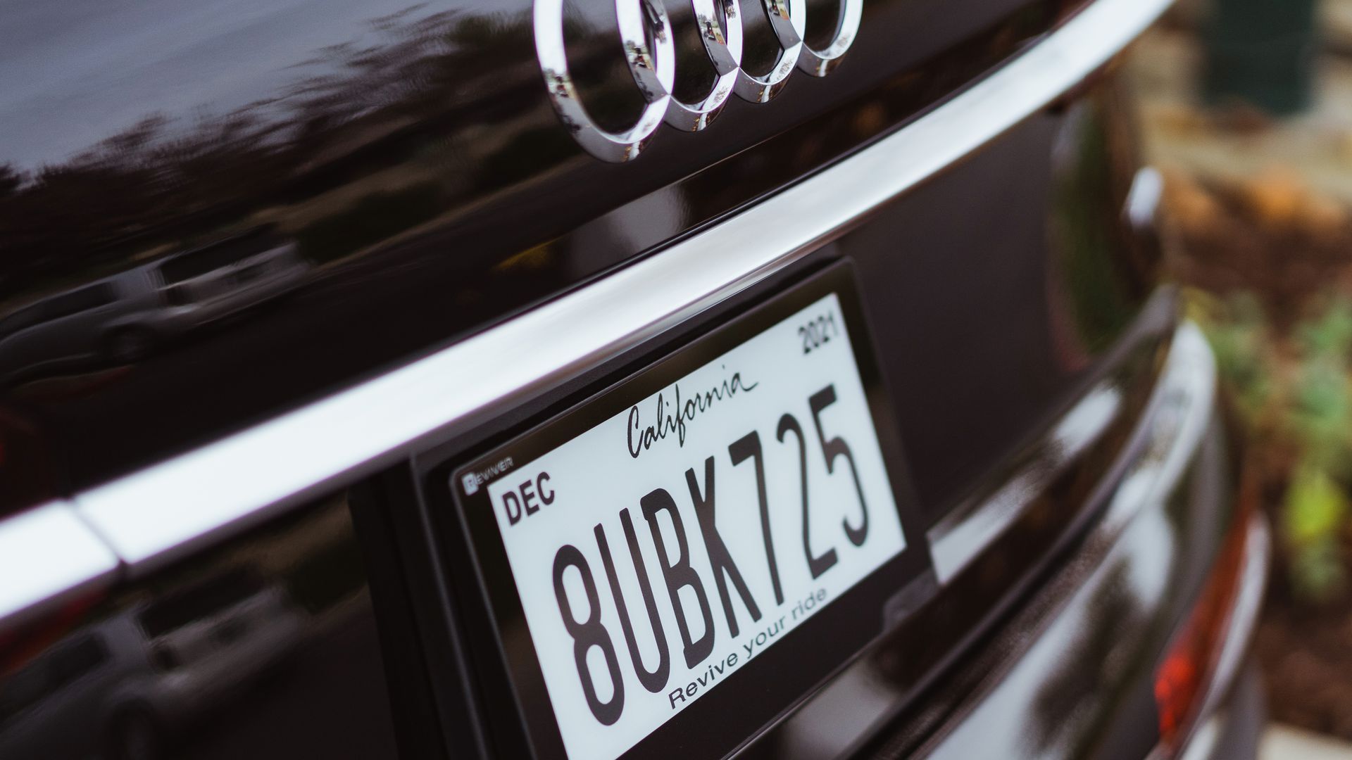 A digital license plate on the back of an Audi.