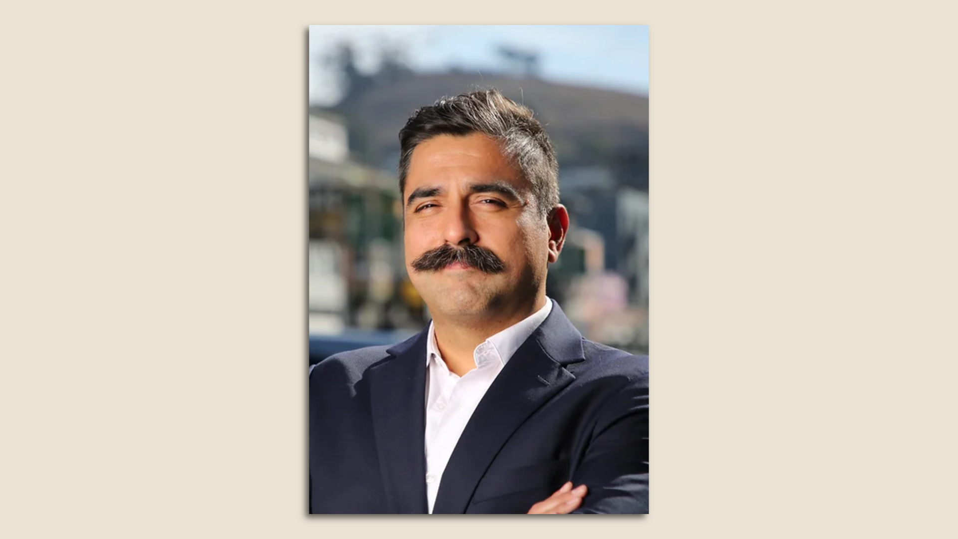 Photo of Stephen Torres in a suit looking at the camera