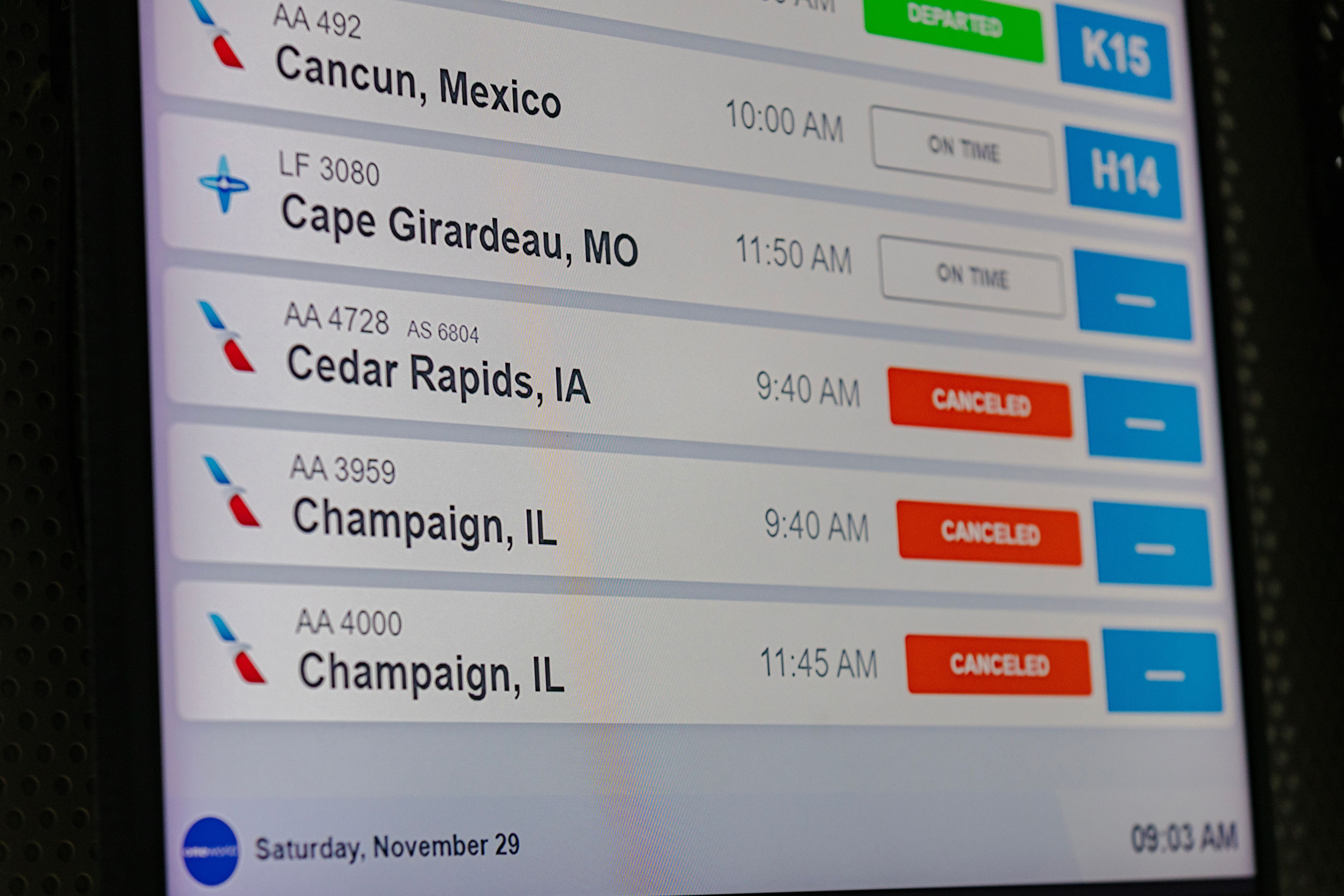 Flight information board at Chicago’s O’Hare International Airport displaying numerous flight cancellations during a winter storm.