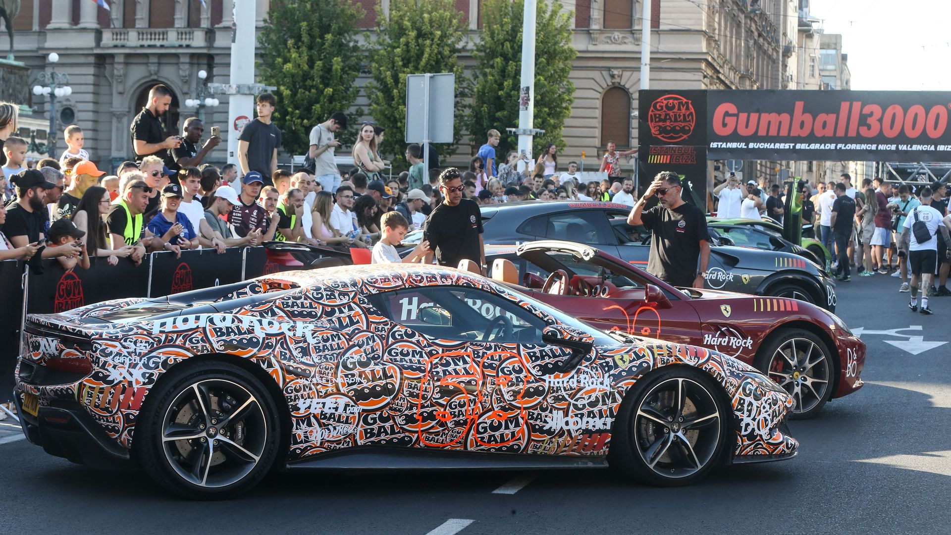 Image shows supercars parked on a street.