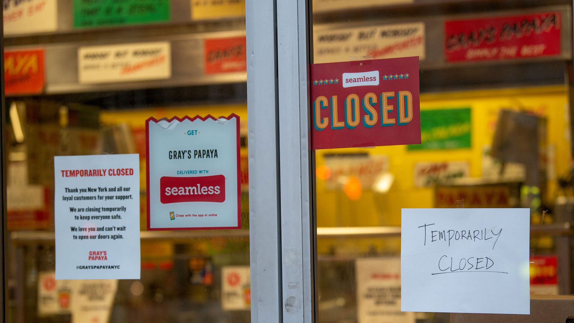 In this image, a door has several "closed" signs