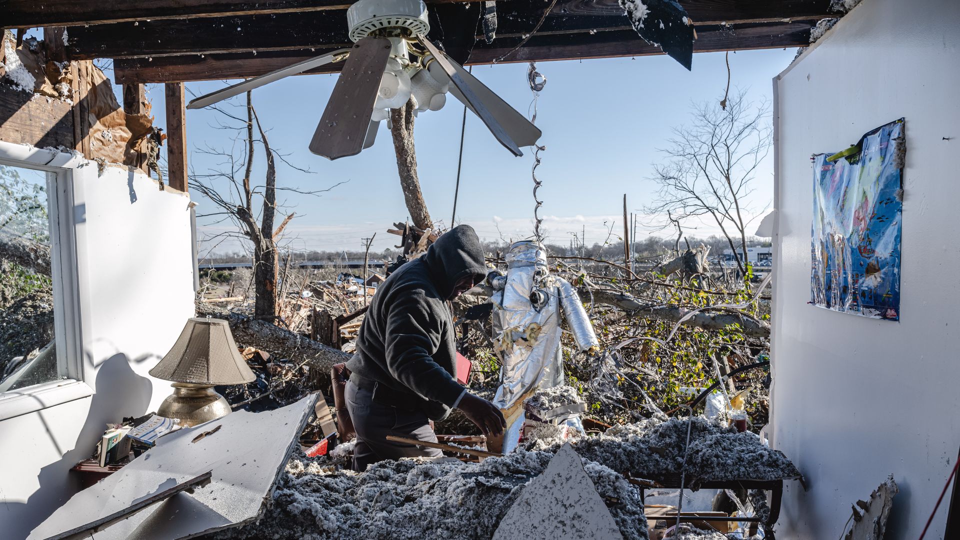 Ronald Harris searches the office of Sabbath Day Church of God in Christ in the aftermath of a tornado on December 10, 2023 in Madison, Tennessee. Multiple long-track tornadoes were reported in northwest Tennessee on December 9th causing multiple deaths and injuries and widespread damage.