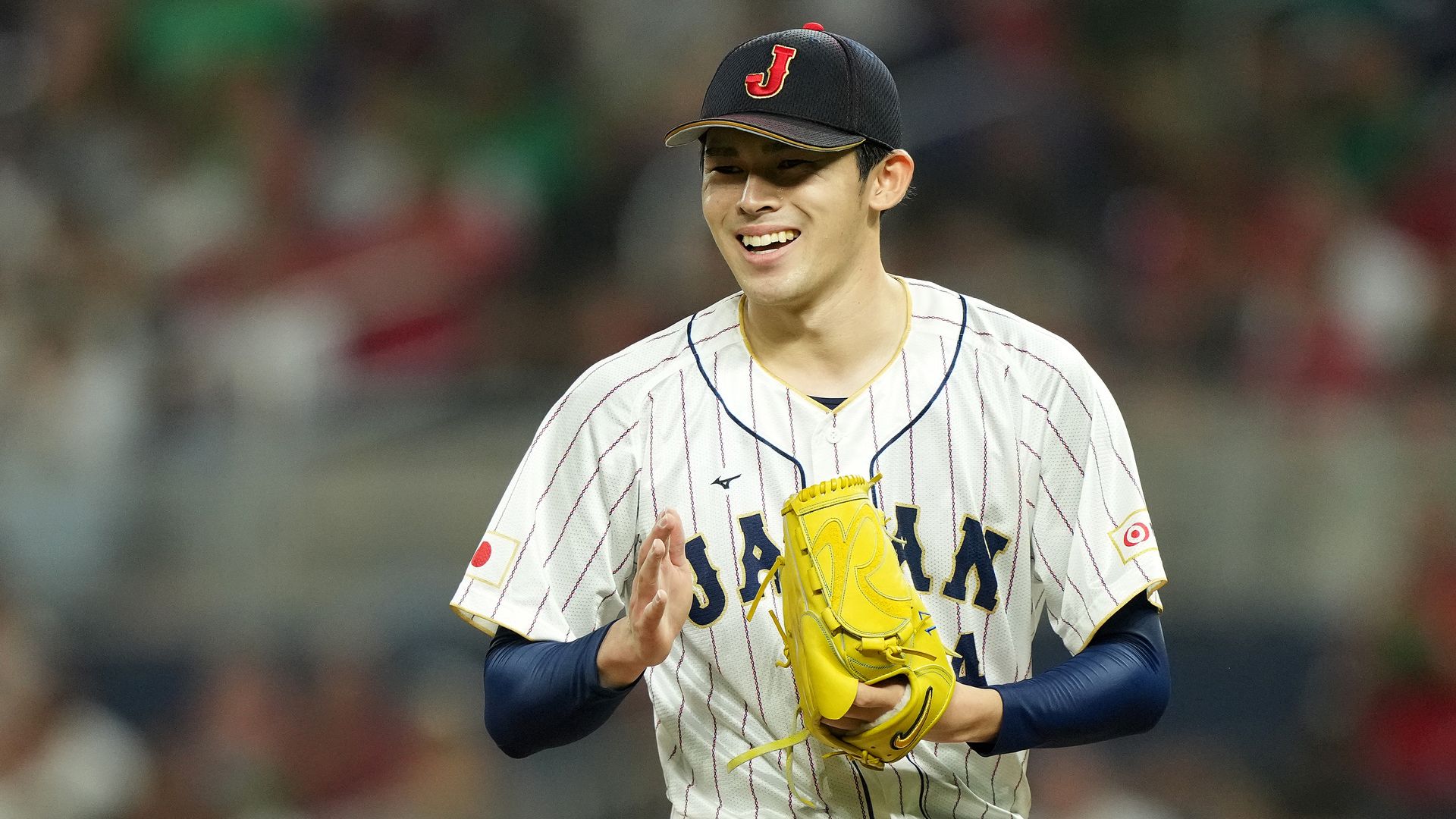 Photo of a baseball player with a glove on the mound during a game
