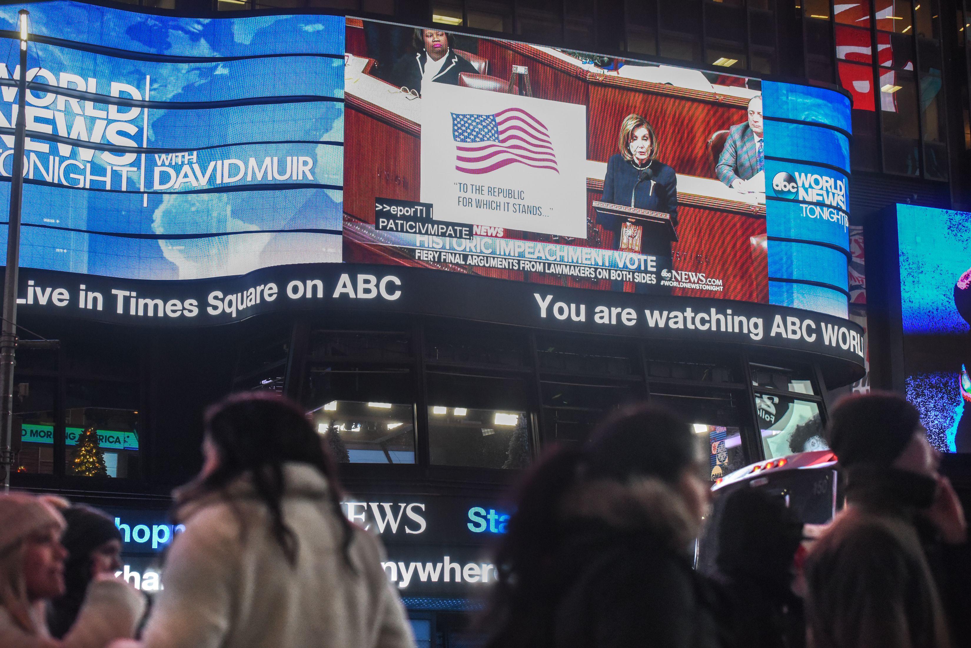  People watch the impeachment debate in Times Square on December 18, 2019 in New York