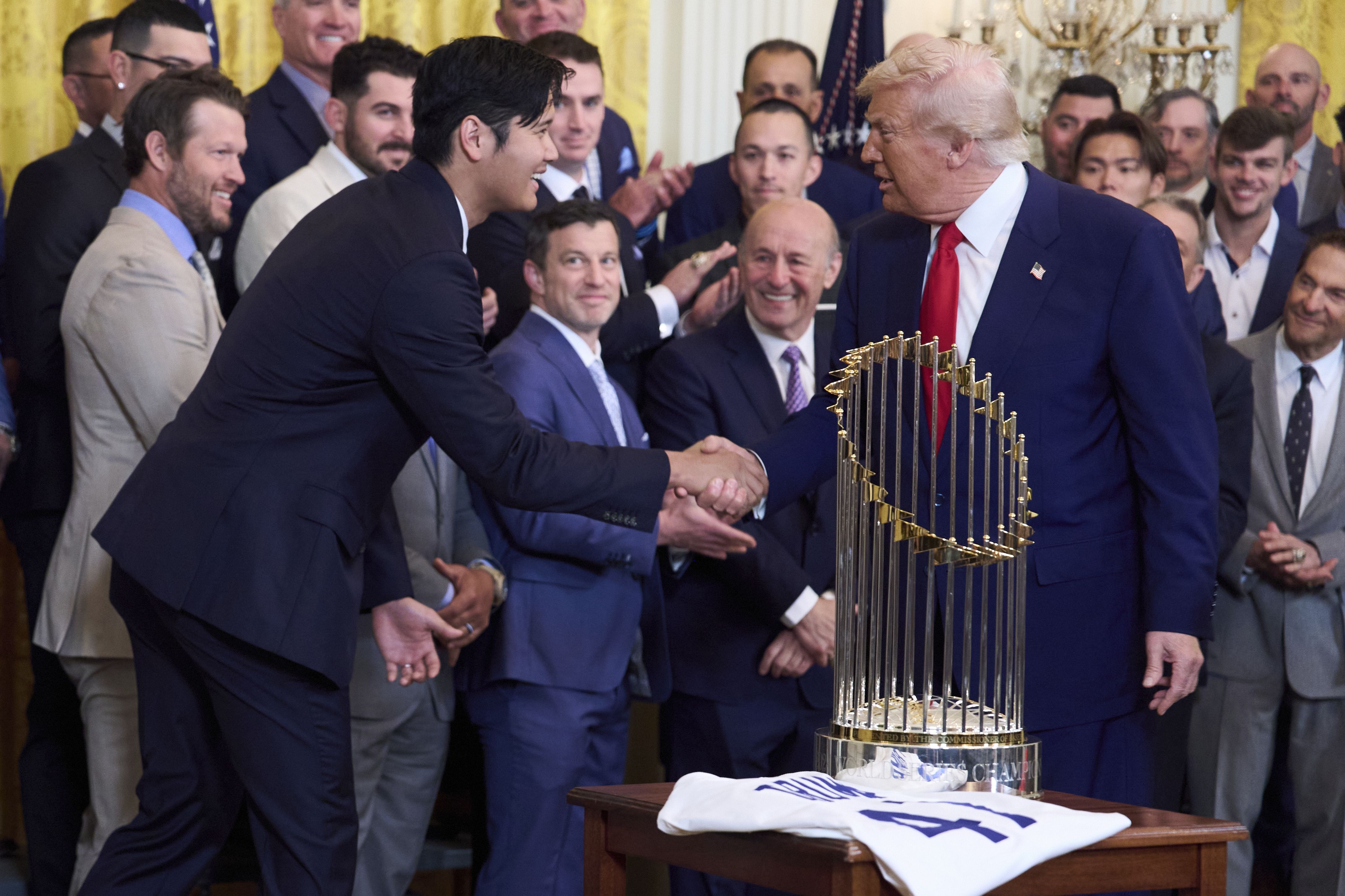 President Donald Trump shakes hands with Los Angeles Dodgers' Shohei Ohtani during a ceremony to honor the Major League Baseball 2024 World Series Champion team in the East Room of the White House, Monday, April 7, 2025, in Washington. (AP Photo/Evan Vucci)