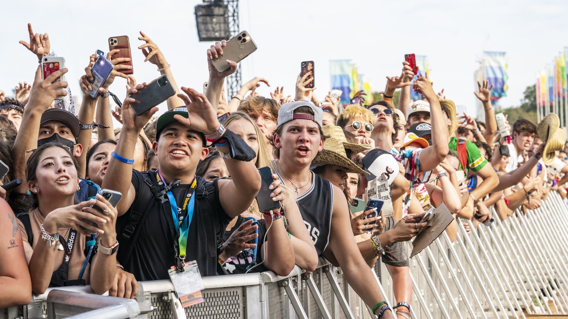 A crowd stands behind a barricade at Austin City Limits music festival