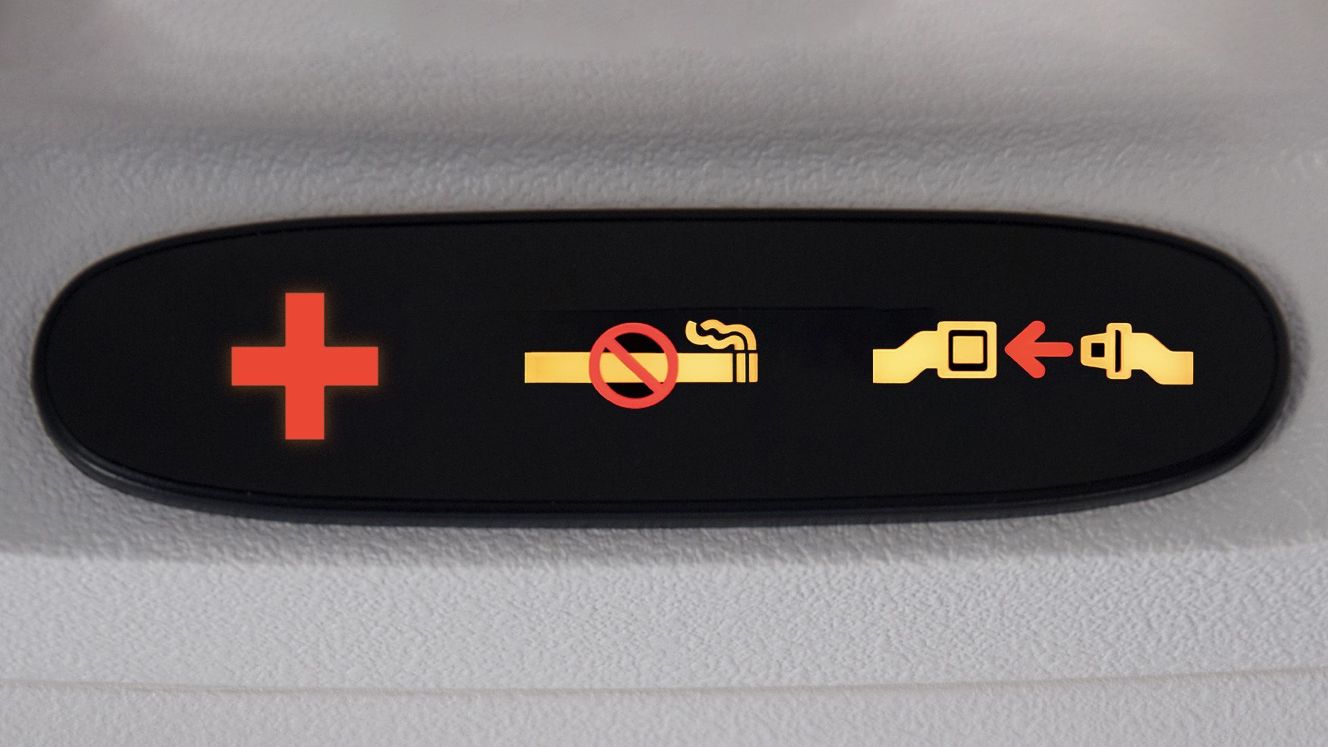 Illustration of plane seatbelt and no smoking lights with a lit up red plus