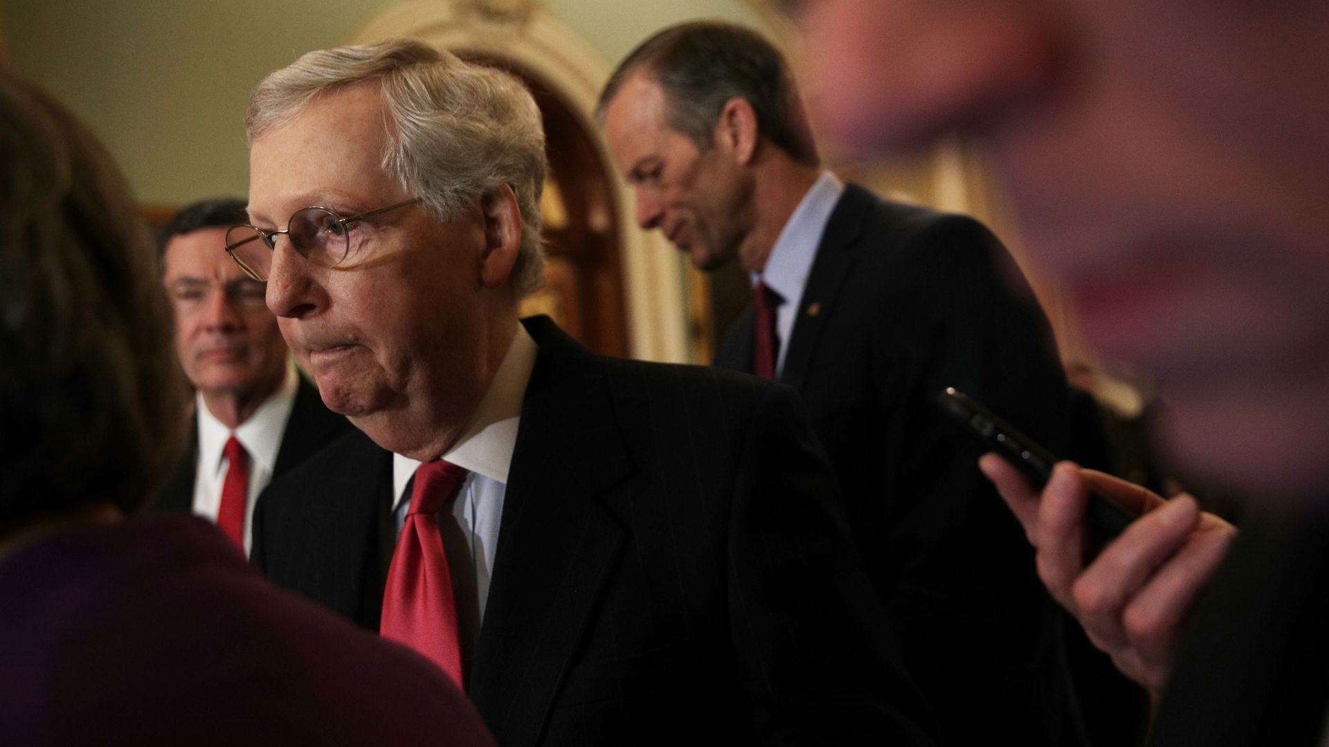 In this image, Mitch McConnell walks by a crowd.