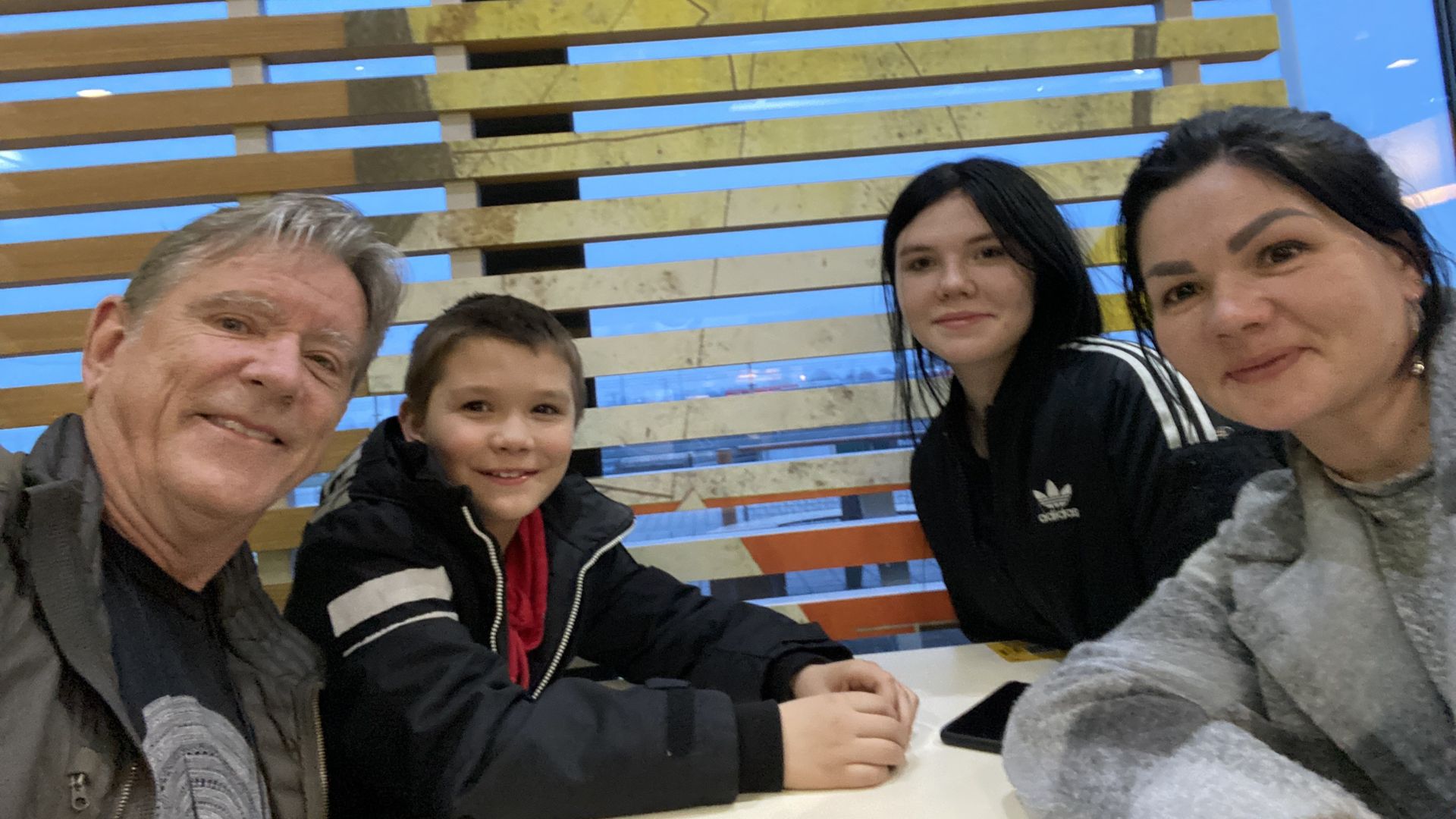 Lewis Price with a woman and her two children at a McDonald's in Poland. A large labrador belonging to the family waited in the car. Photo: courtesy Lewis Price