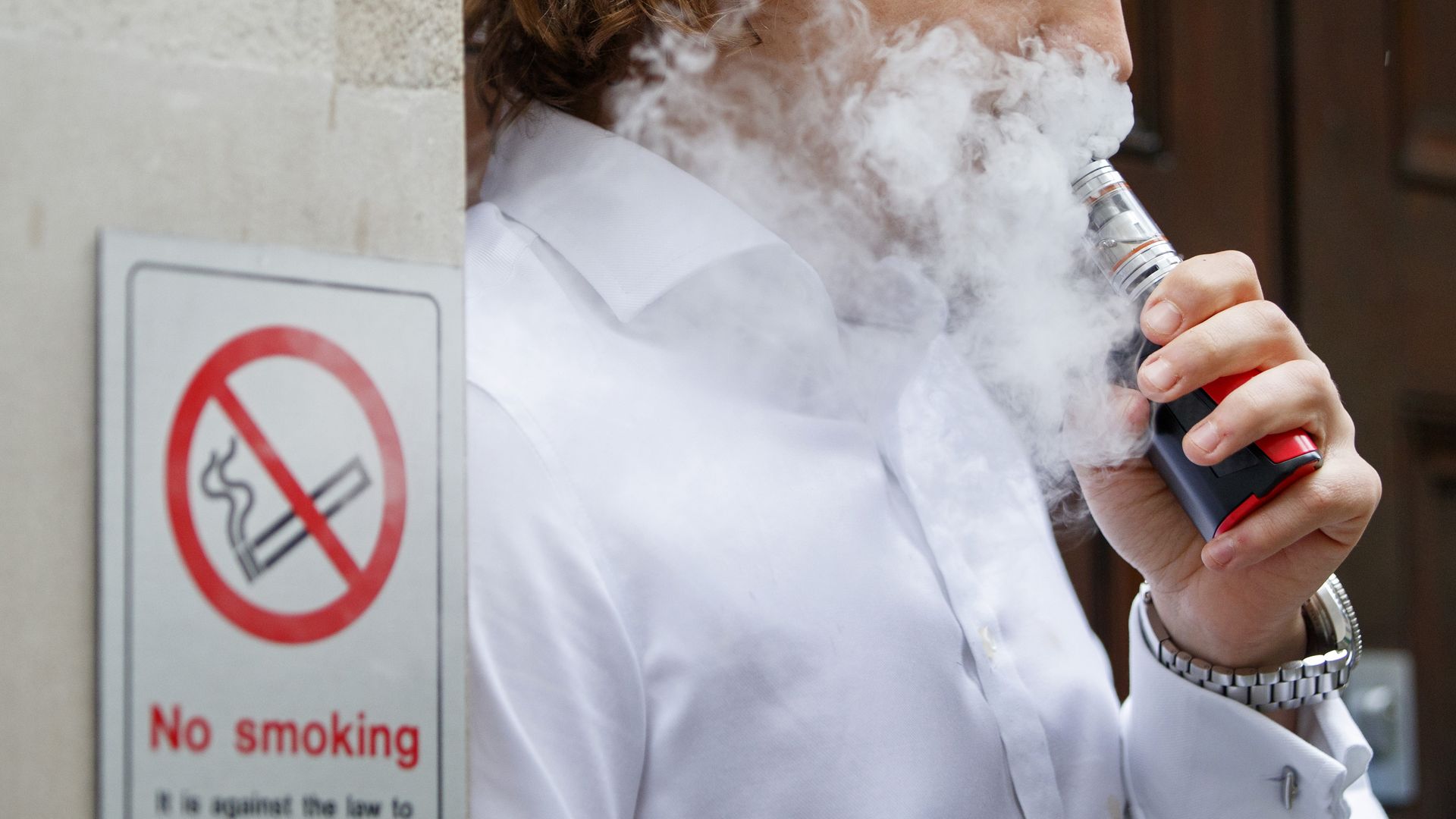 A man smokes an electronic vaping machine.