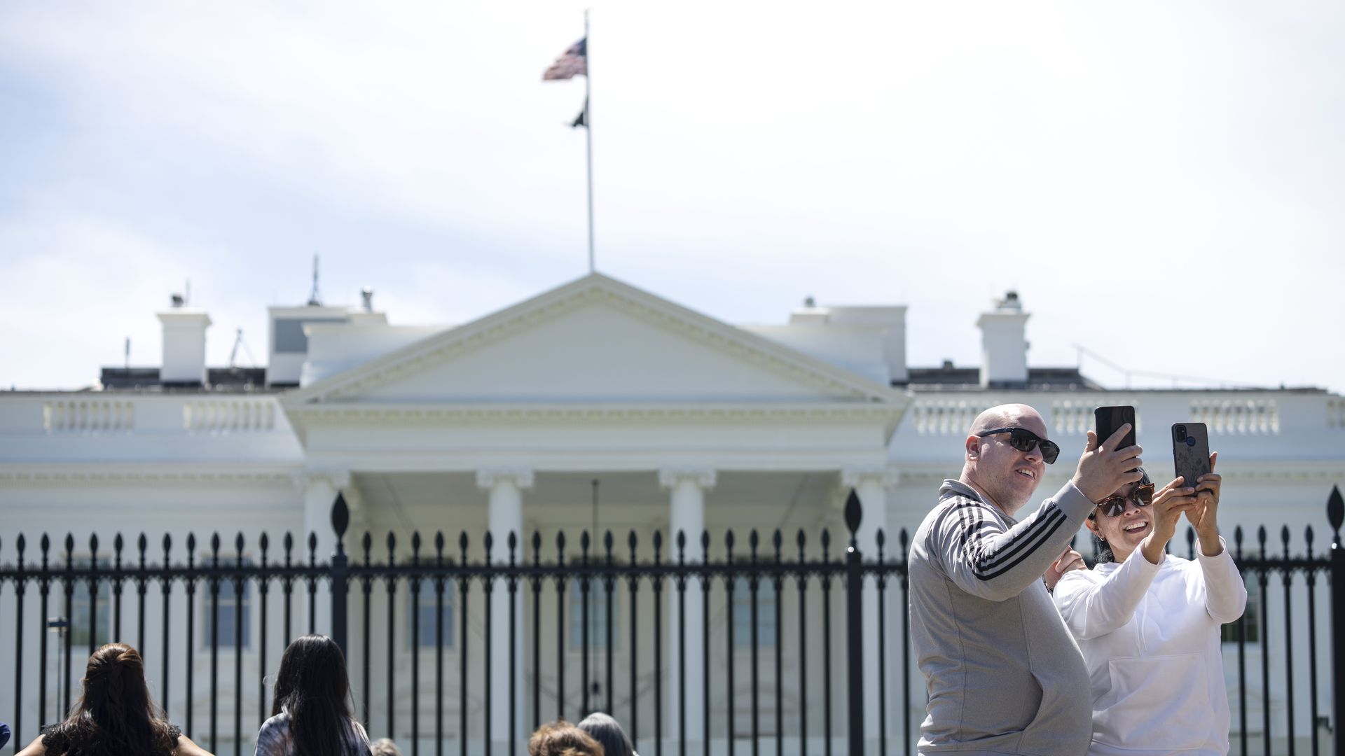 Tourists are seen snapping a selfie in front of the White House.