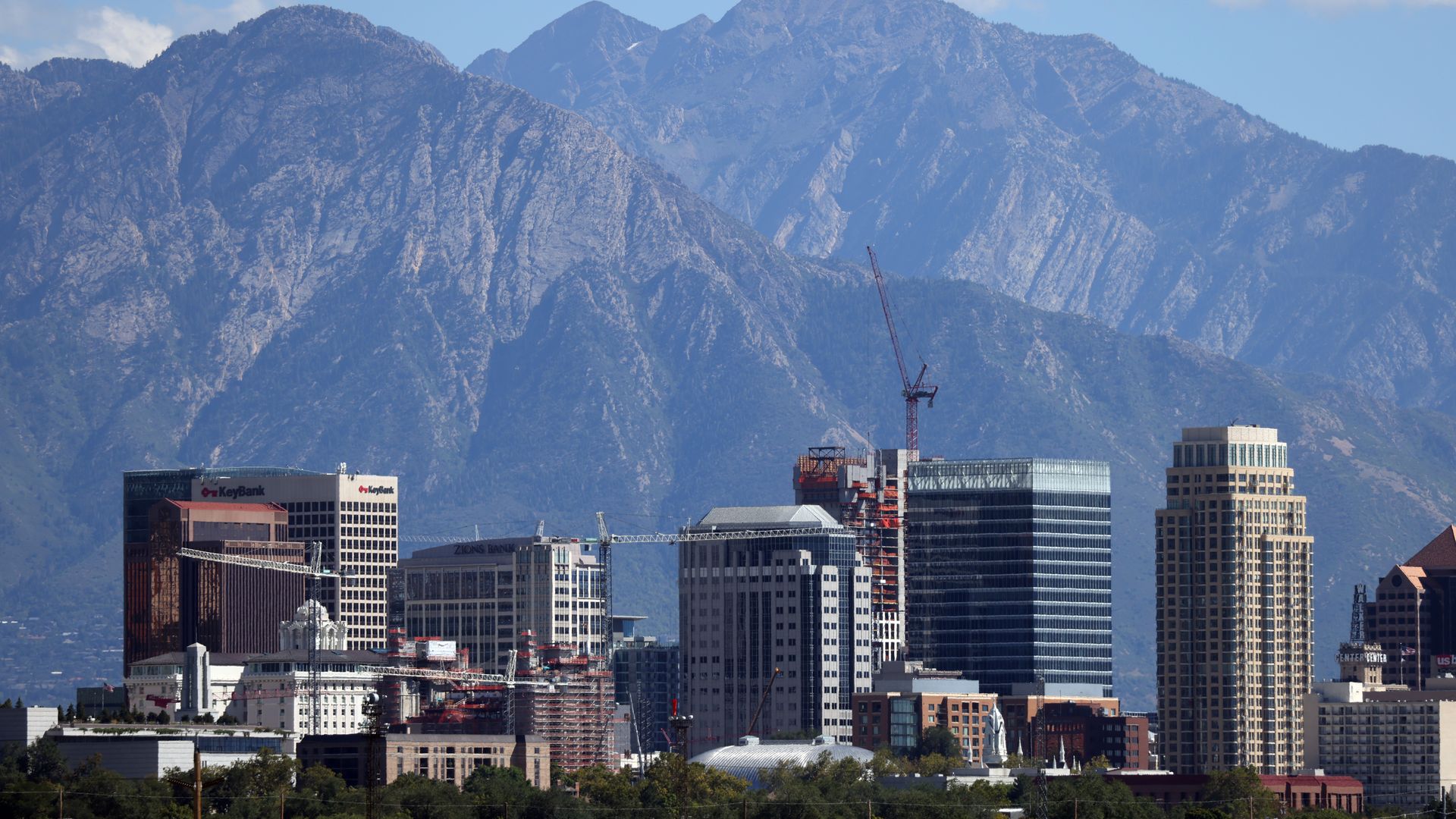The Church of Jesus Christ of Latter-day Saints' Salt Lake Temple and luxury apartments of the City Creek Center can be seen framing downtown Salt Lake City on September 5, 2023, in front of mountains.