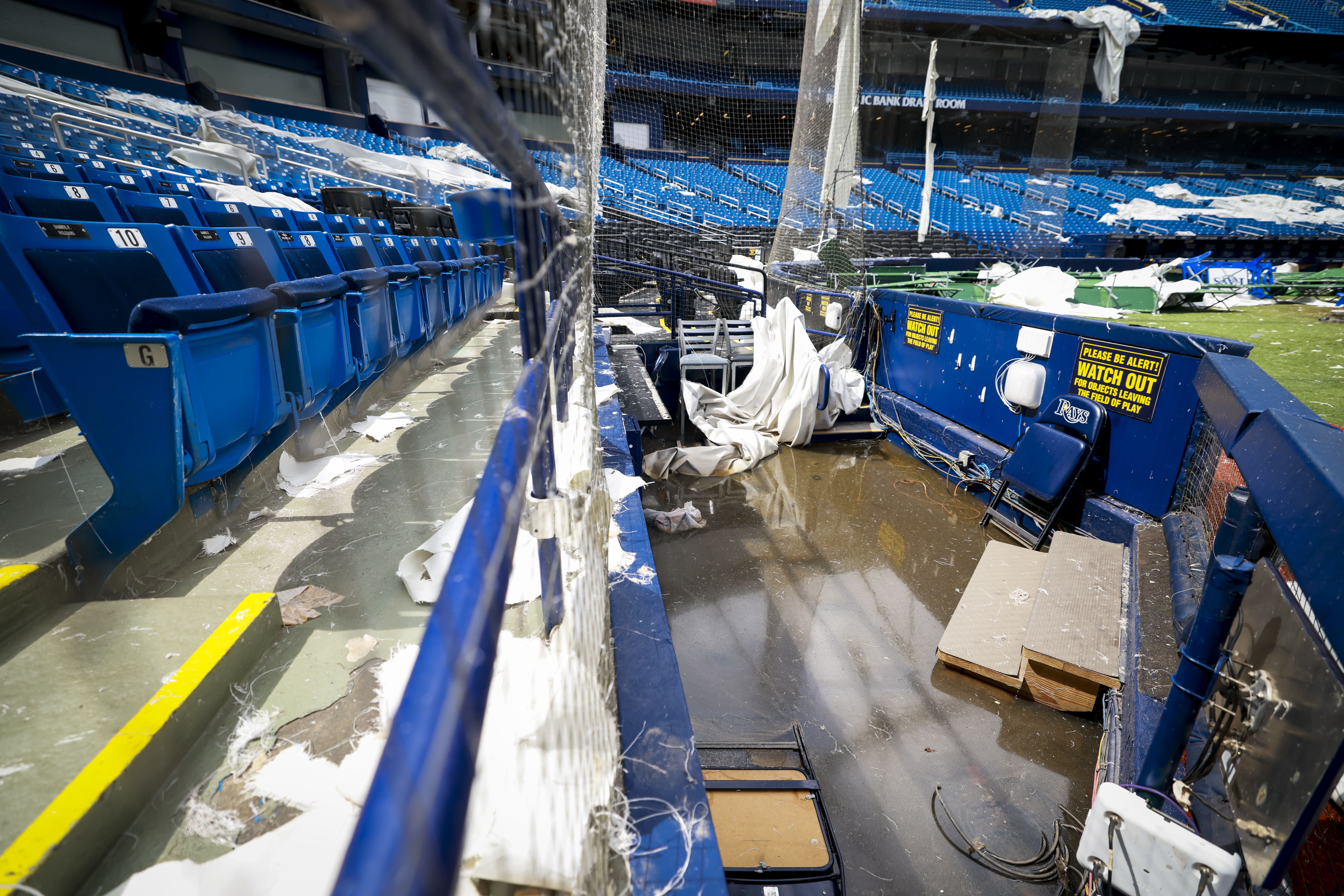 Front row seats covered in debris and soaked inside Tropicana Field.
