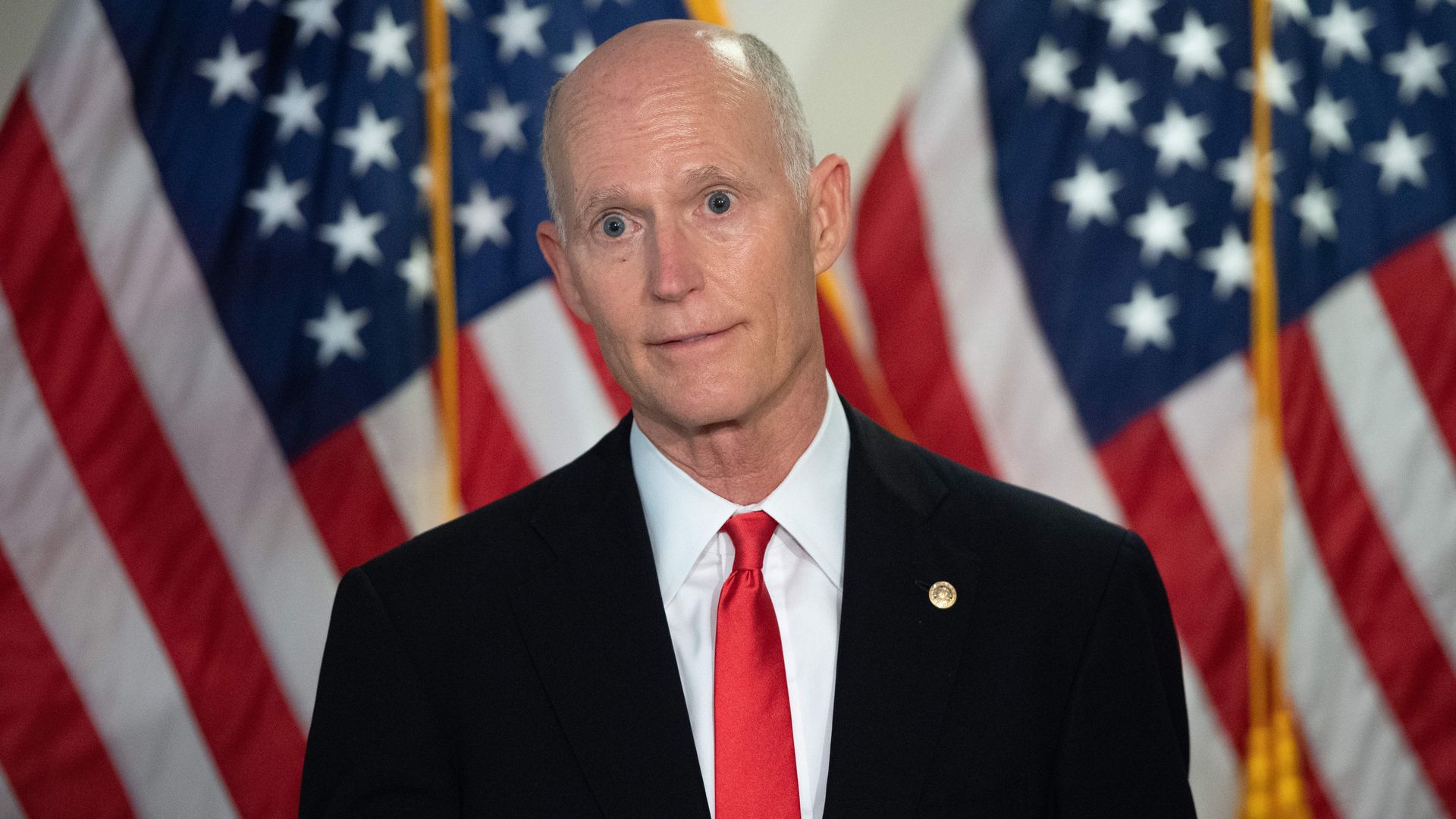 Rick Scott is seen during a news conference.