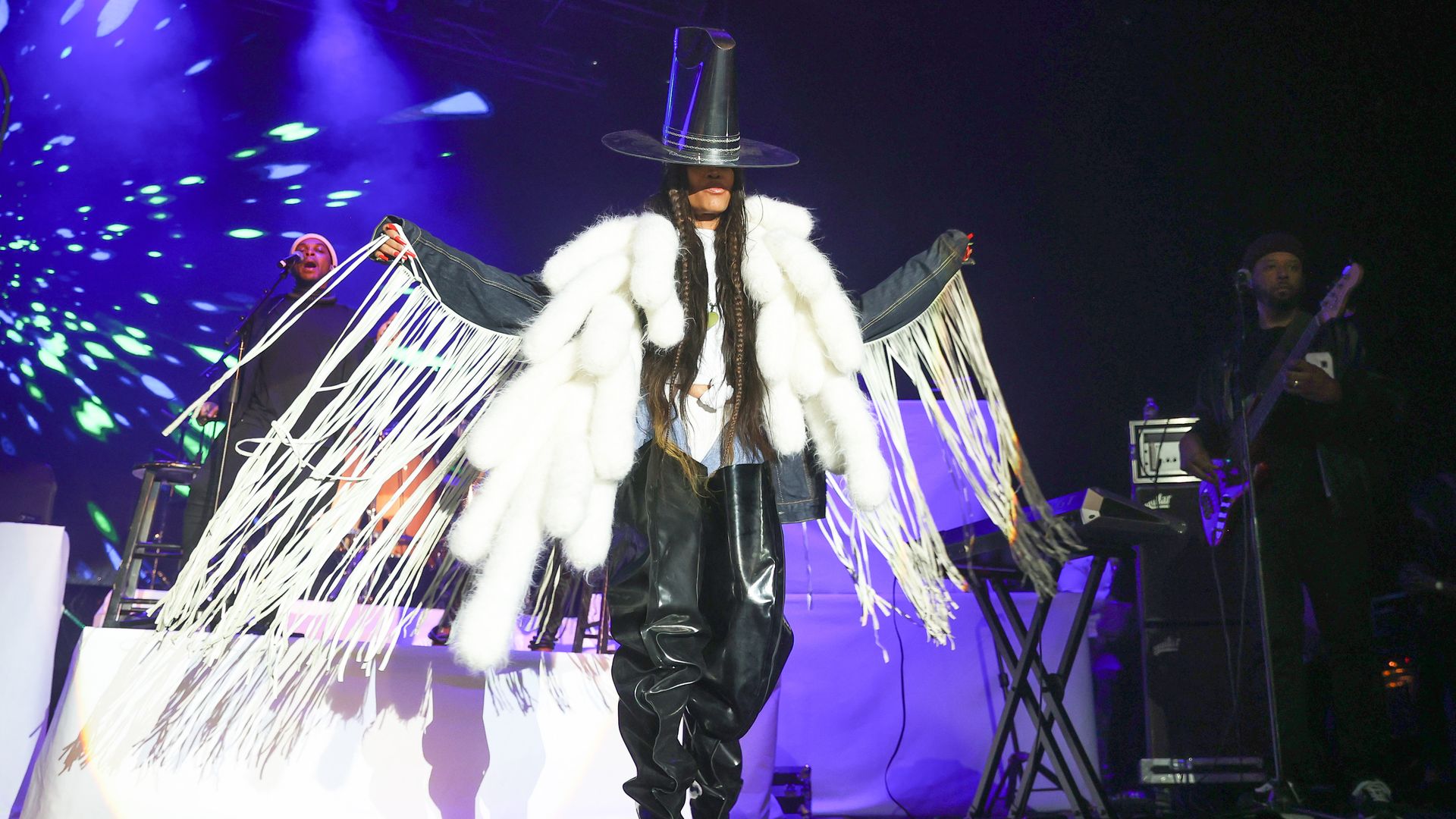 Erykah Badu performs wearing a fringe costume. 