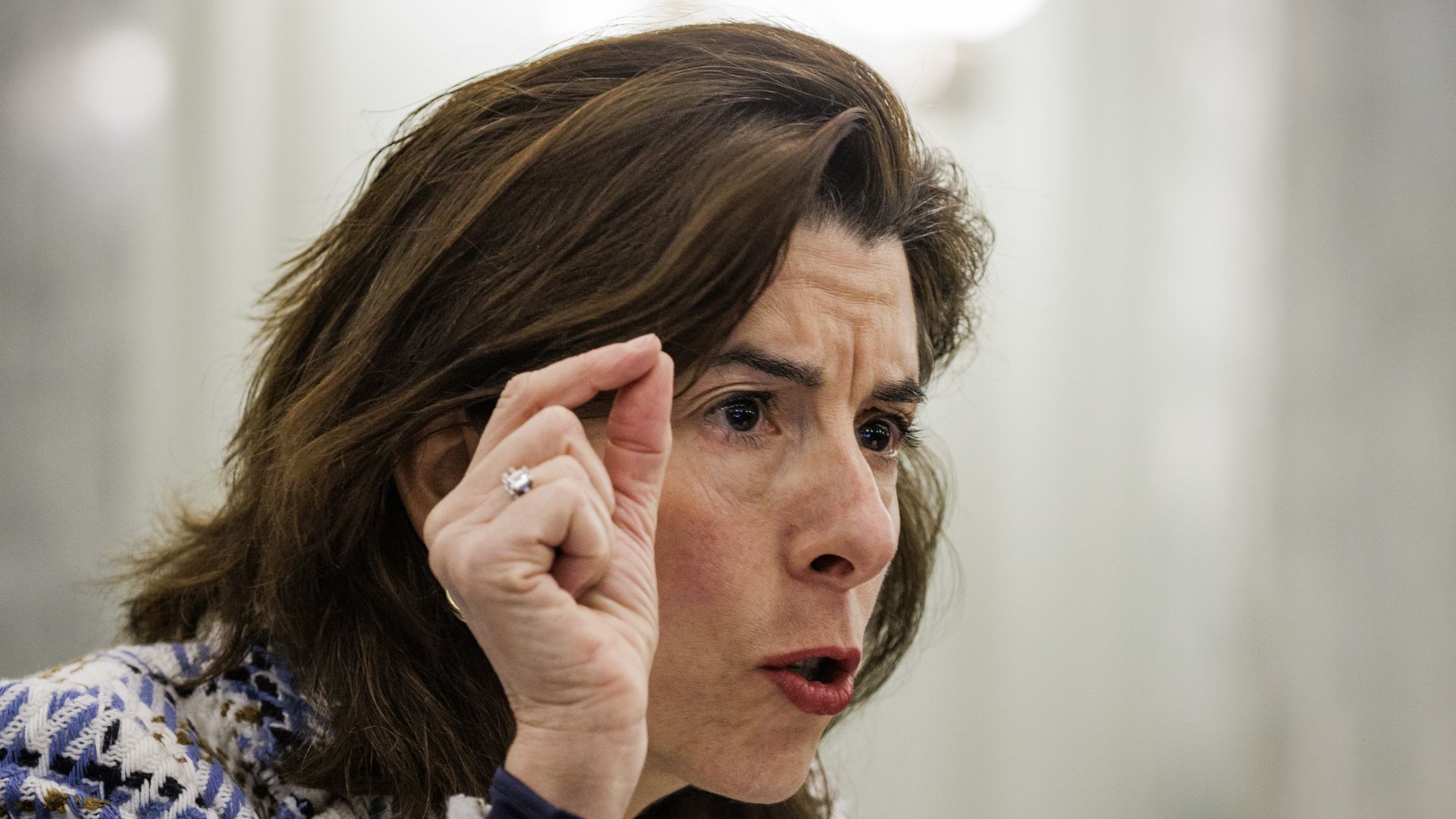 Gina Raimondo puts her finger in the air