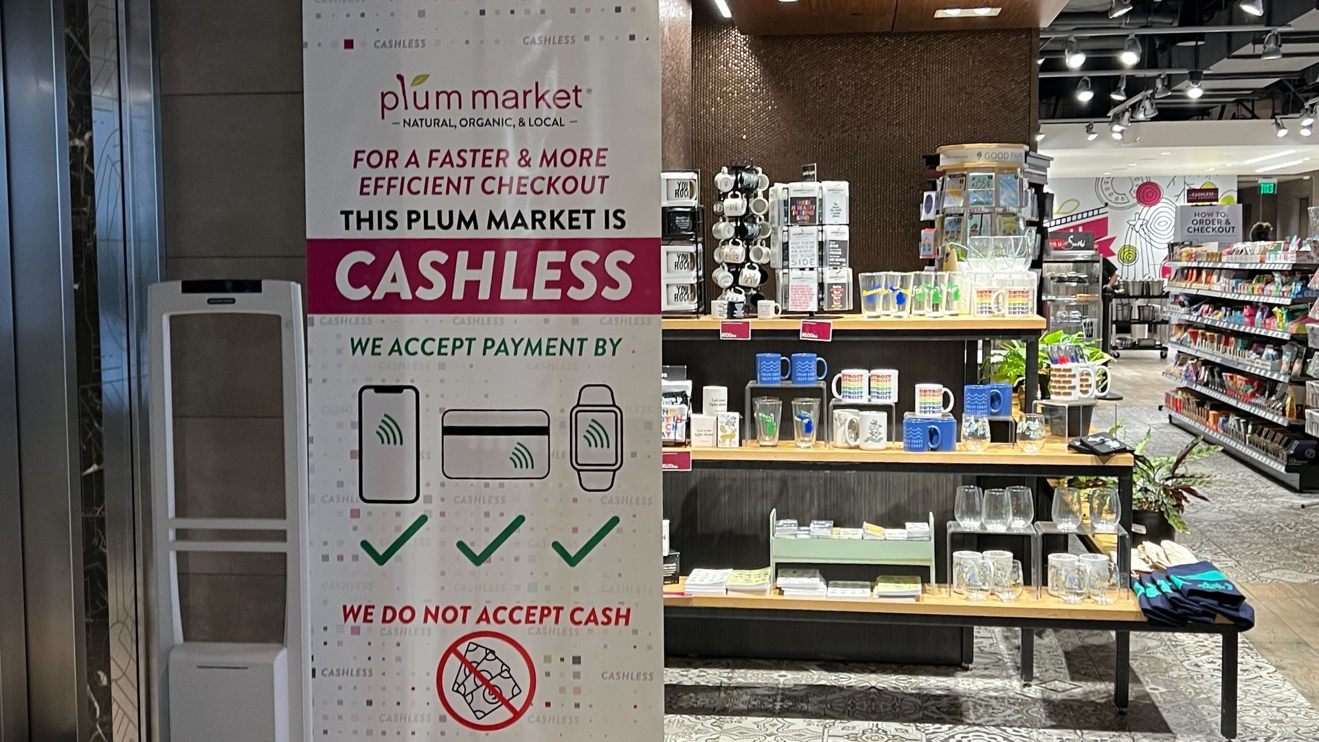 A sign in Plum Market says it is cashless "for a faster and more efficient checkout." 