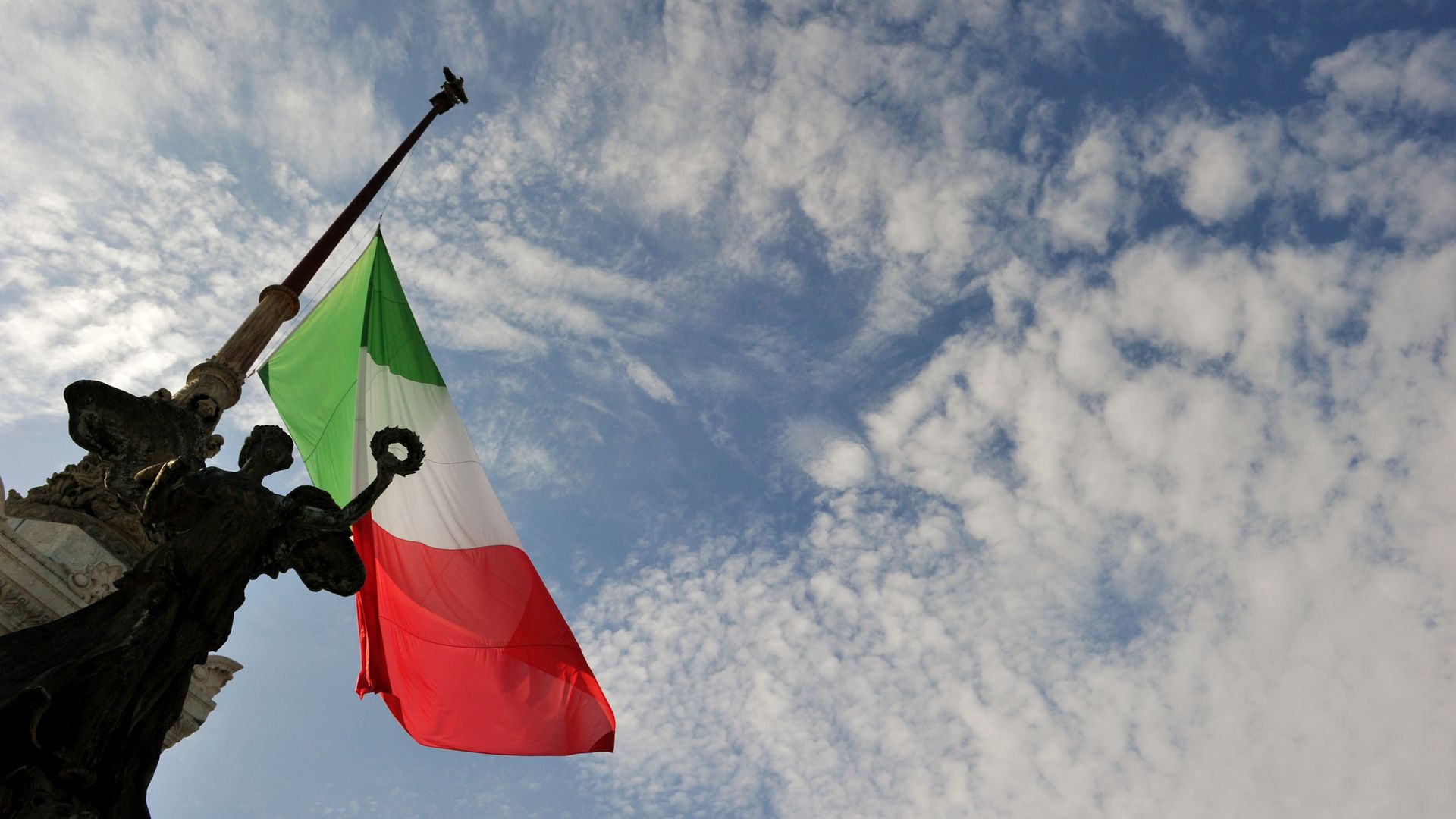 A picture shows a statue and the Italian flag at half mast at the Vittoriano unknown soldier monument in central Rome on October 4, 2013. 